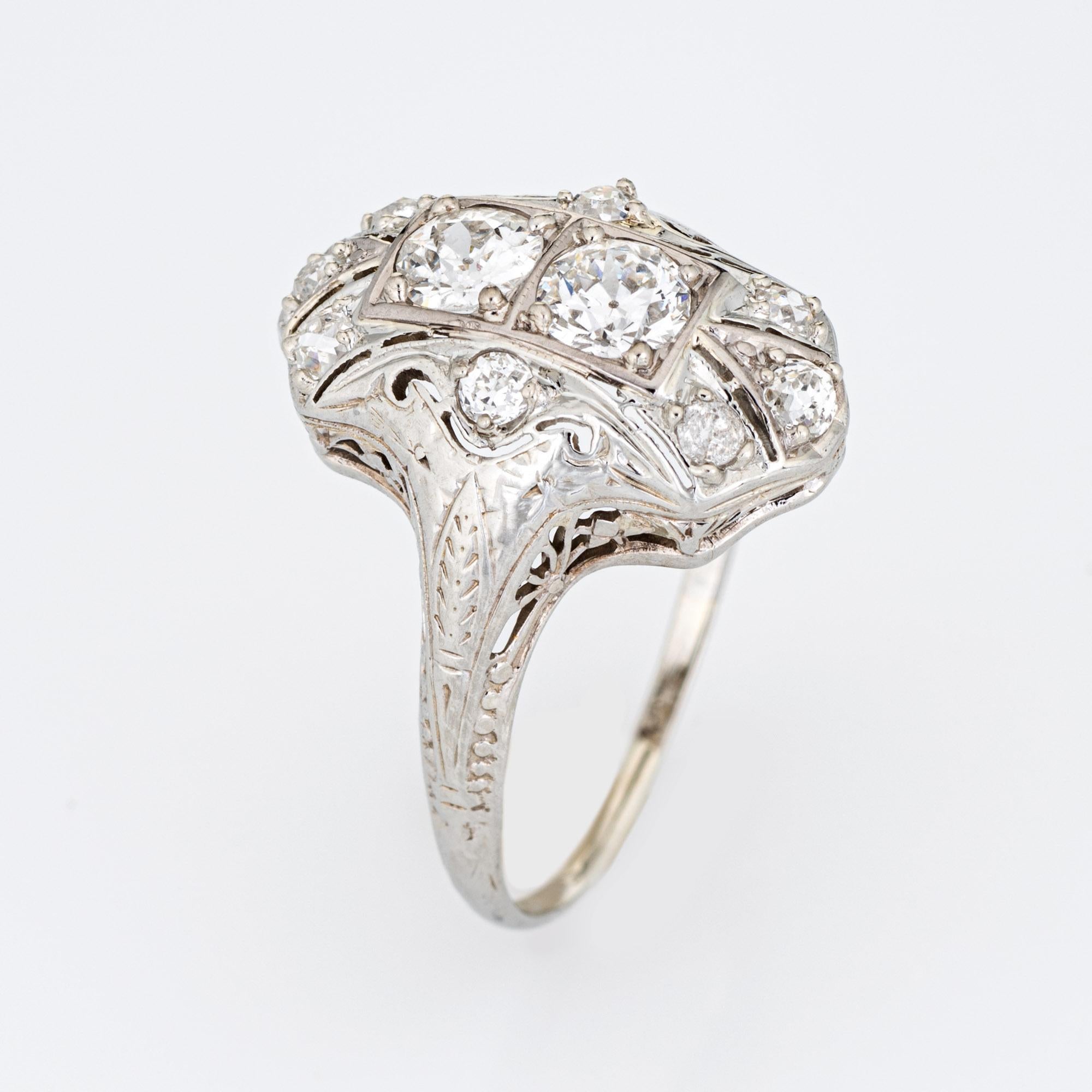 Elegant & finely detailed Belais Art Deco era ring (circa 1920s to 1930s) crafted in 14k white gold. 

Two centrally mounted old European cut diamonds are estimated at 0.48 carats each. A further 8 old mine cut diamonds total an estimated 0.42