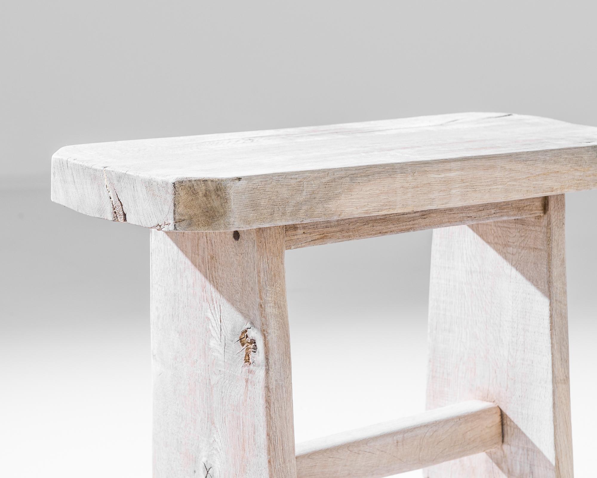 A simple oak stool from Belgium. Restored with a bleached oak finish, the light tone and natural texture recall a countryside locale.
