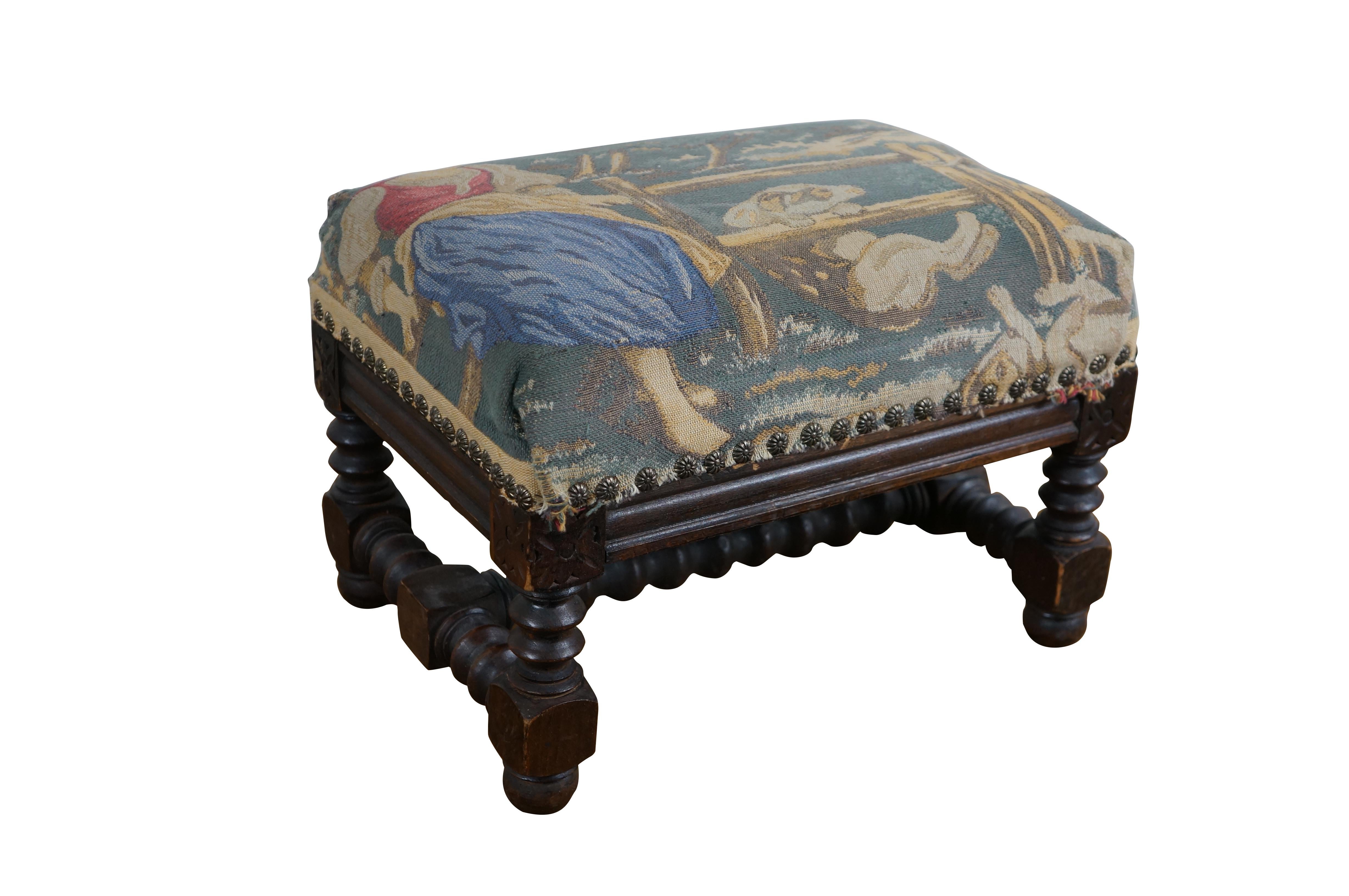 Mid to early 20th century quartersawn oak footstool / ottoman featuring turned / carved legs, padded top covered in an embroidered needlepoint tapestry depicting a charming French provincial peasant girl seated on a fence with a pair of dogs.