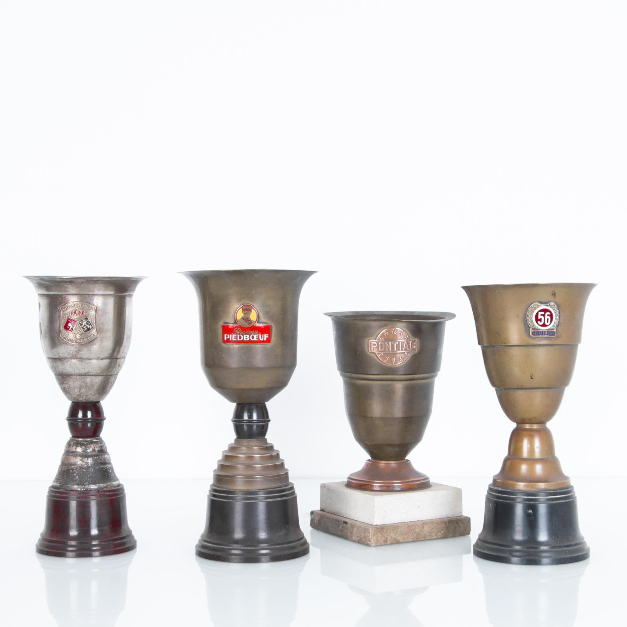 Brass, silver, polished wood and marble. Elegance from an era passed by, some evidence of wear, tarnished silver plating, for a great vintage look. Representing the winners of various races from the 1950s Belgium, emblazoned with logos, sponsors and