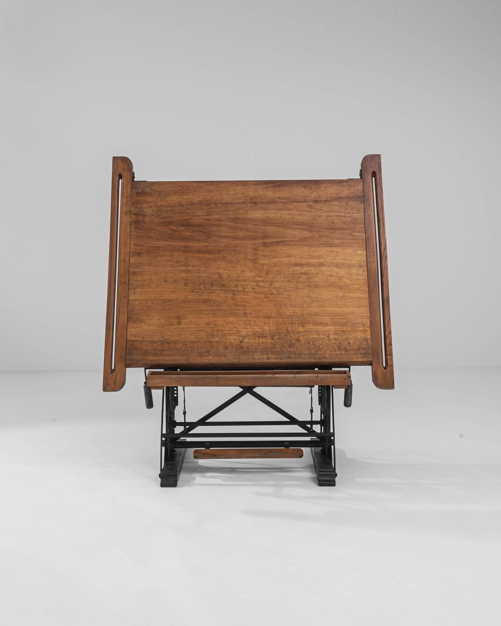 This vintage drawing table is a beautiful example of Industrial elegance. Produced in Brussels in the early 20th century by the Kahn brothers, this piece would have likely originally been used as a draftsman’s table in an architect’s or surveyor’s