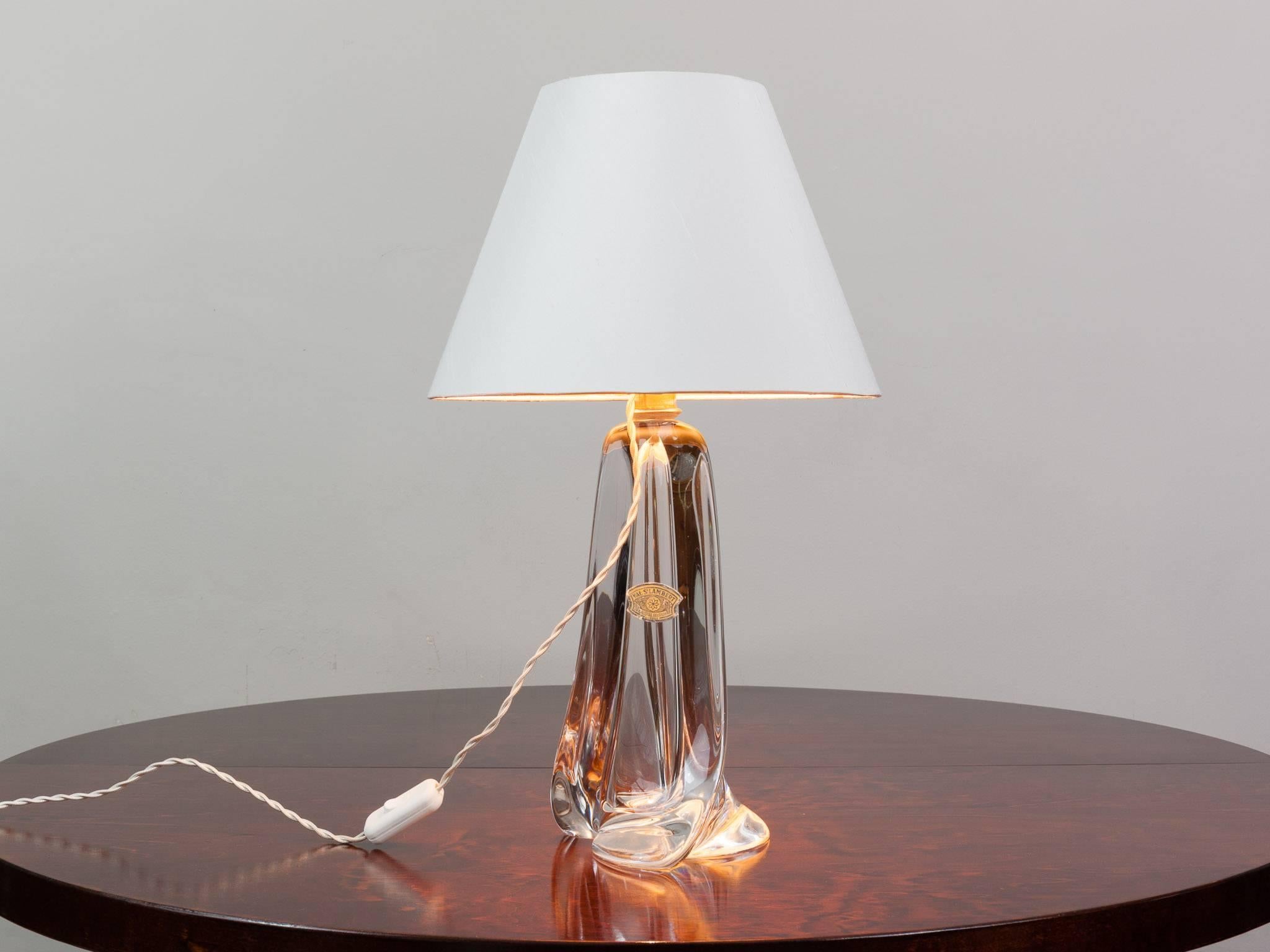1960s Belgium Val Saint Lambert handblown clear crystal glass table lamp base which including the original manufactures label. A heavy piece with a wonderful sweeping base. An unusual clear version with a brass fixture. Perfect for a living room,