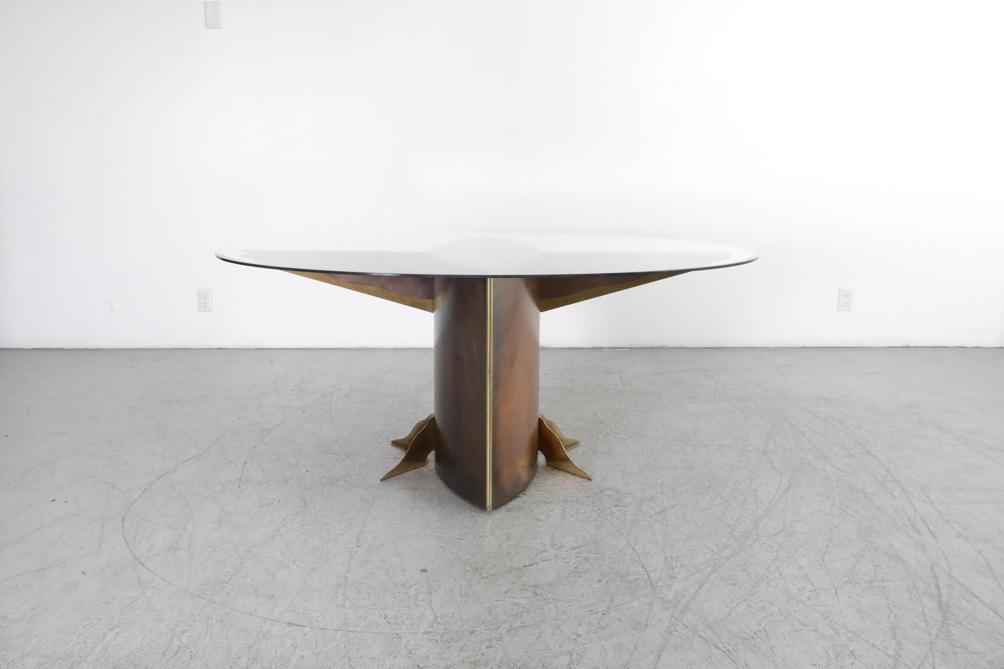 Stunning 1980's, Belgo Chrom made, oval glass dining table with bronzed metal base and gold-plated brass details. The newly fitted glass top has a reverse beveled-edge and comfortable fits up to six. Base is in original condition with age