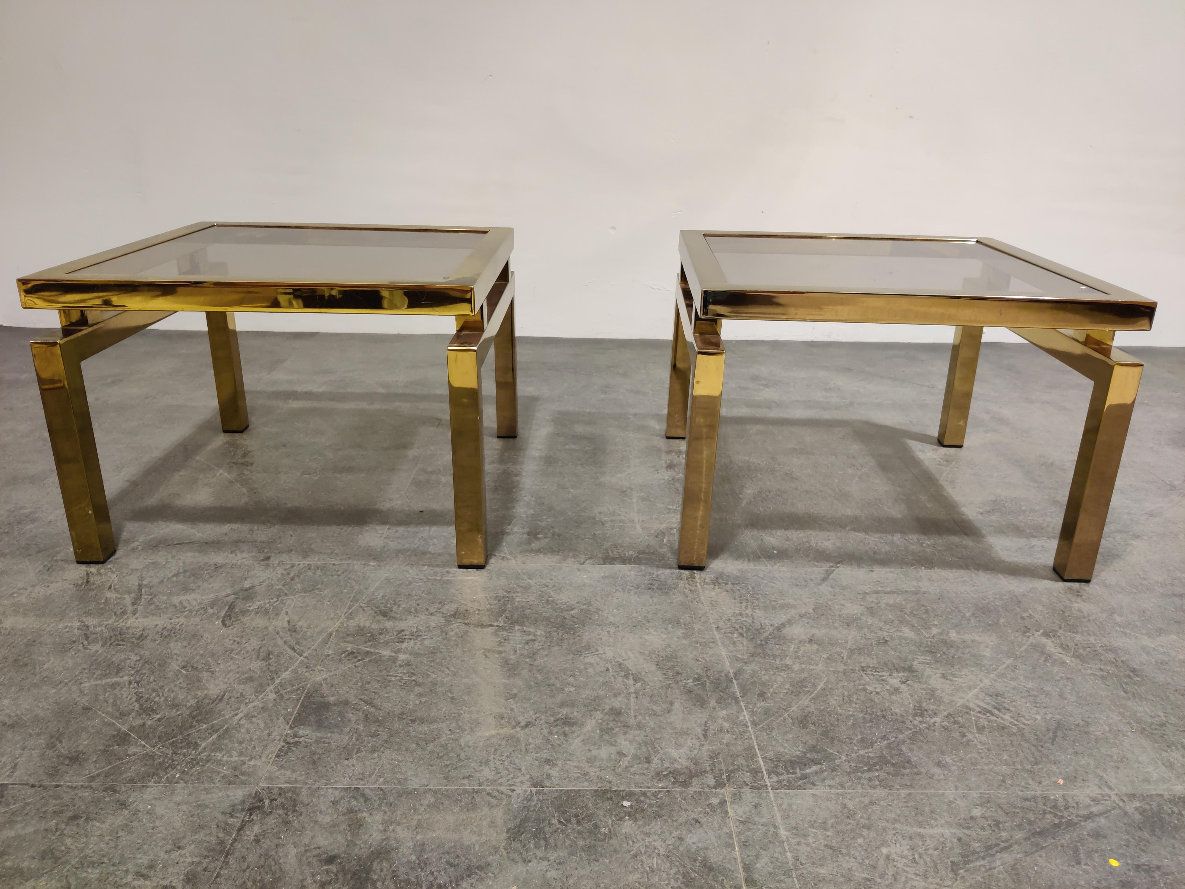 Gorgeous pair of brass coffee tables with floating top and smoked glass.

Very much in the style of Guy Lefevre.

Ideal as side tables or bedside tables.

Condition: brass is in good condition apart from one faded spot on the corner on one of