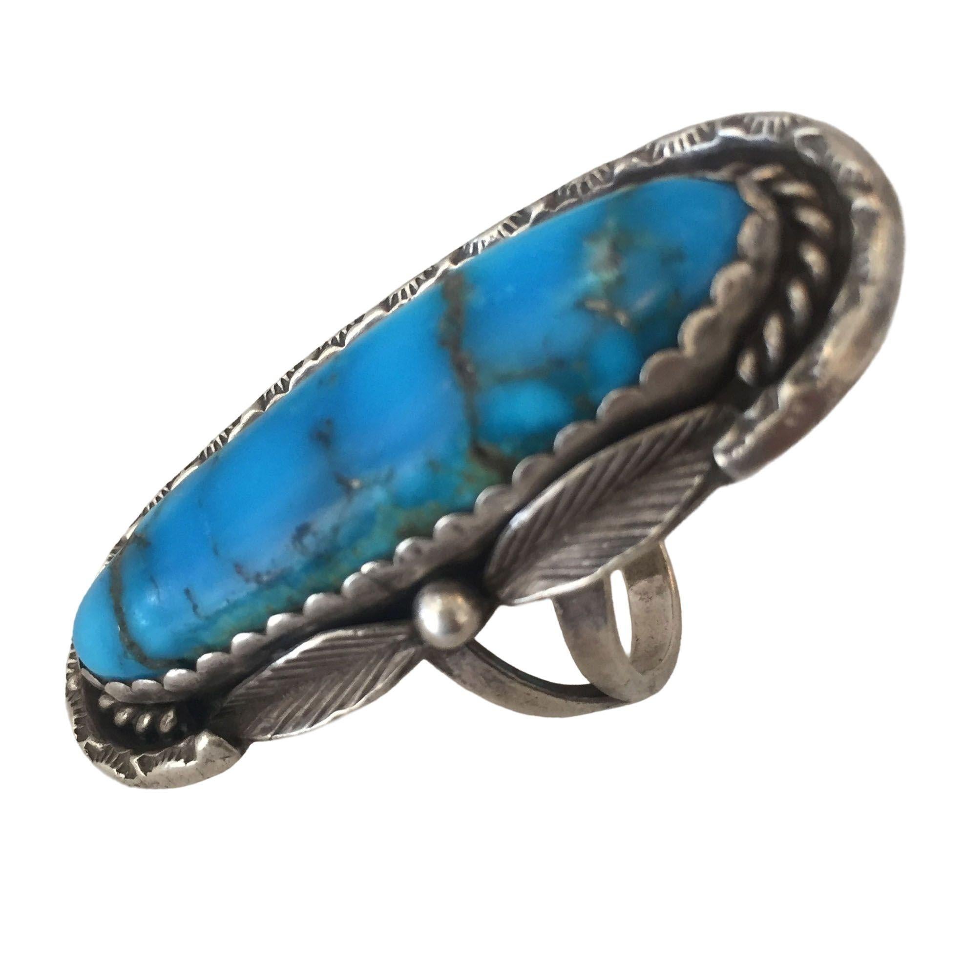 Vintage Southwest style bell trading post ring with a sterling silver band and a large turquoise stone.

Ring size 10.
