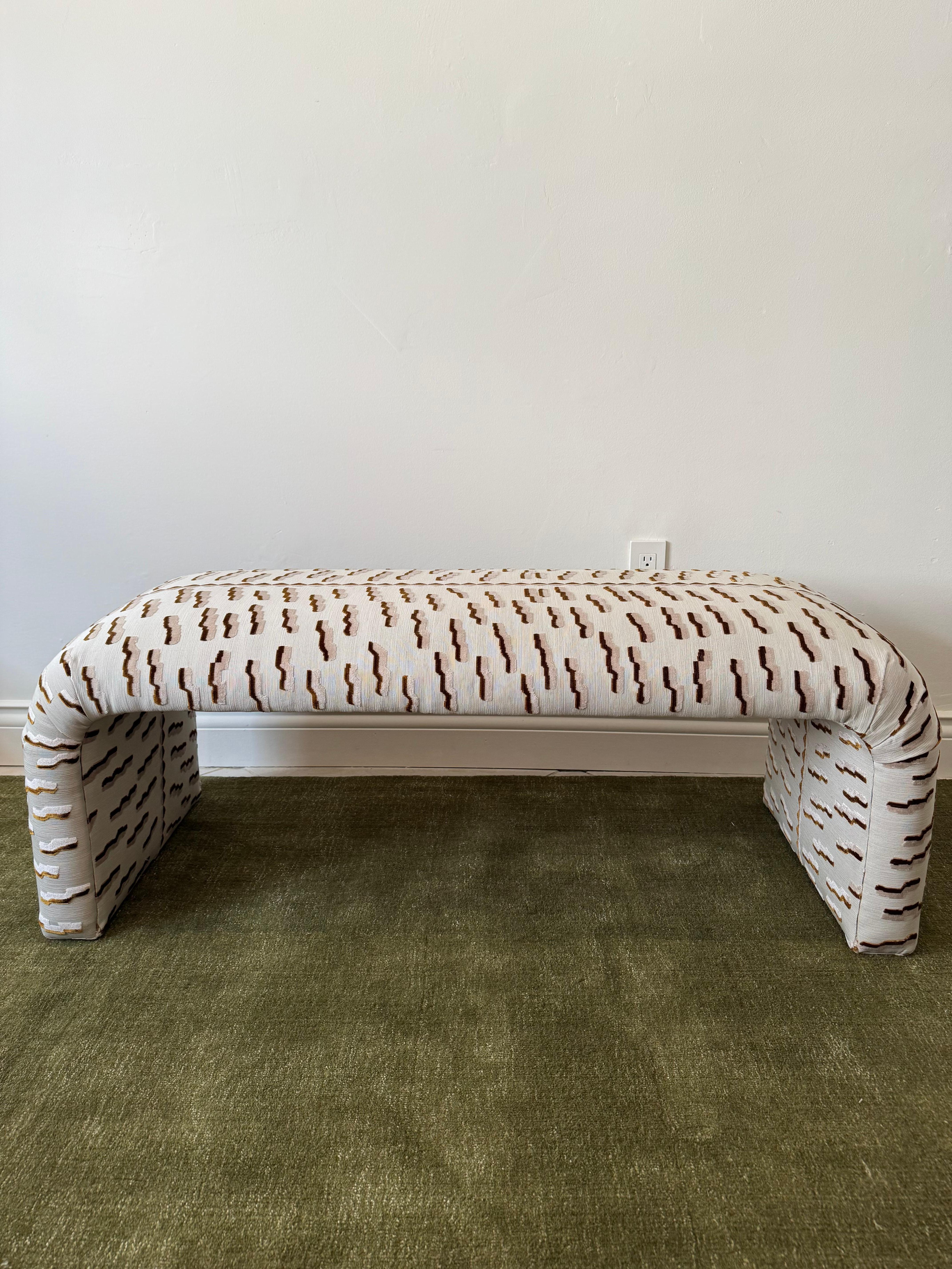 Beautiful vintage sleek waterfall bench newly upholstered in Dedar Milano “Tiger Beat” Jacquard Velvet. The fabric emulates the back of a Tiger with raised velvet stripes and a textured ottoman bottom. 