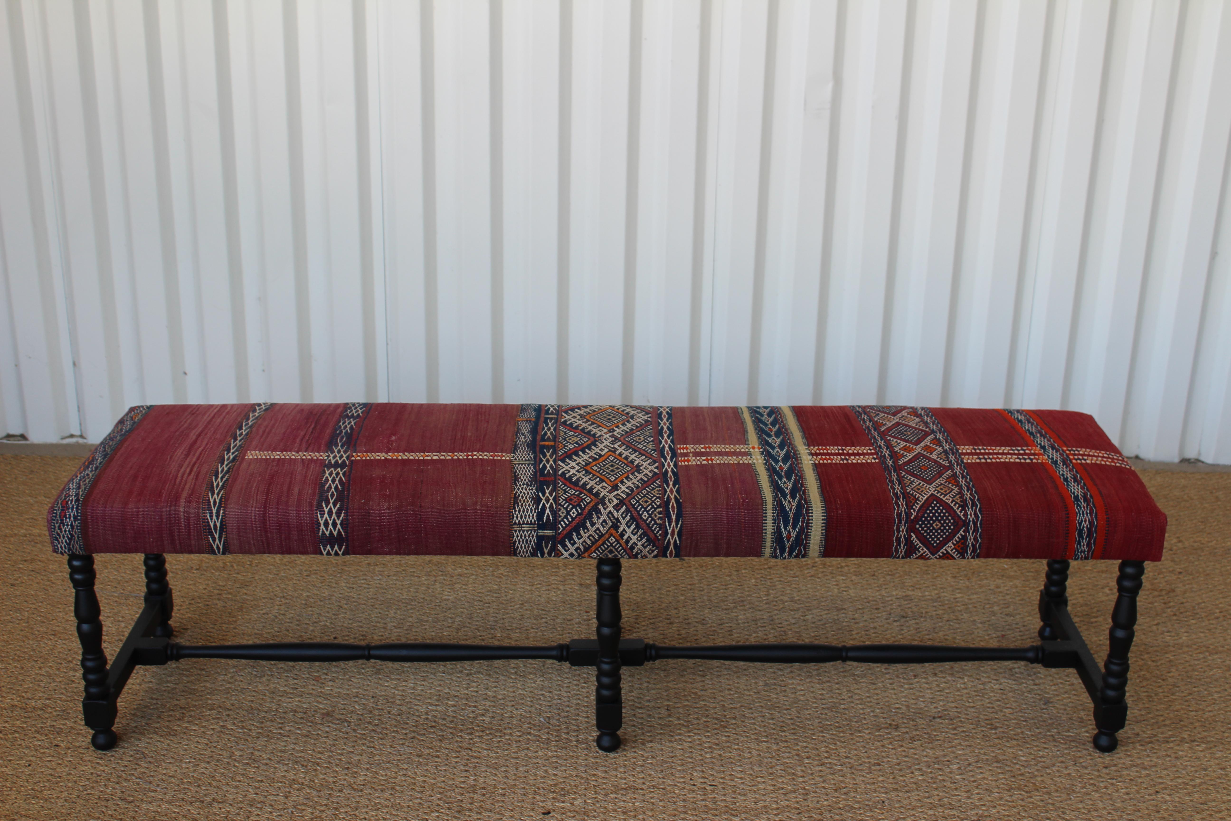 Vintage bench newly upholstered in a vintage flat-weave Kilim rug from Turkey. In excellent condition with new satin black finish on the walnut frame.