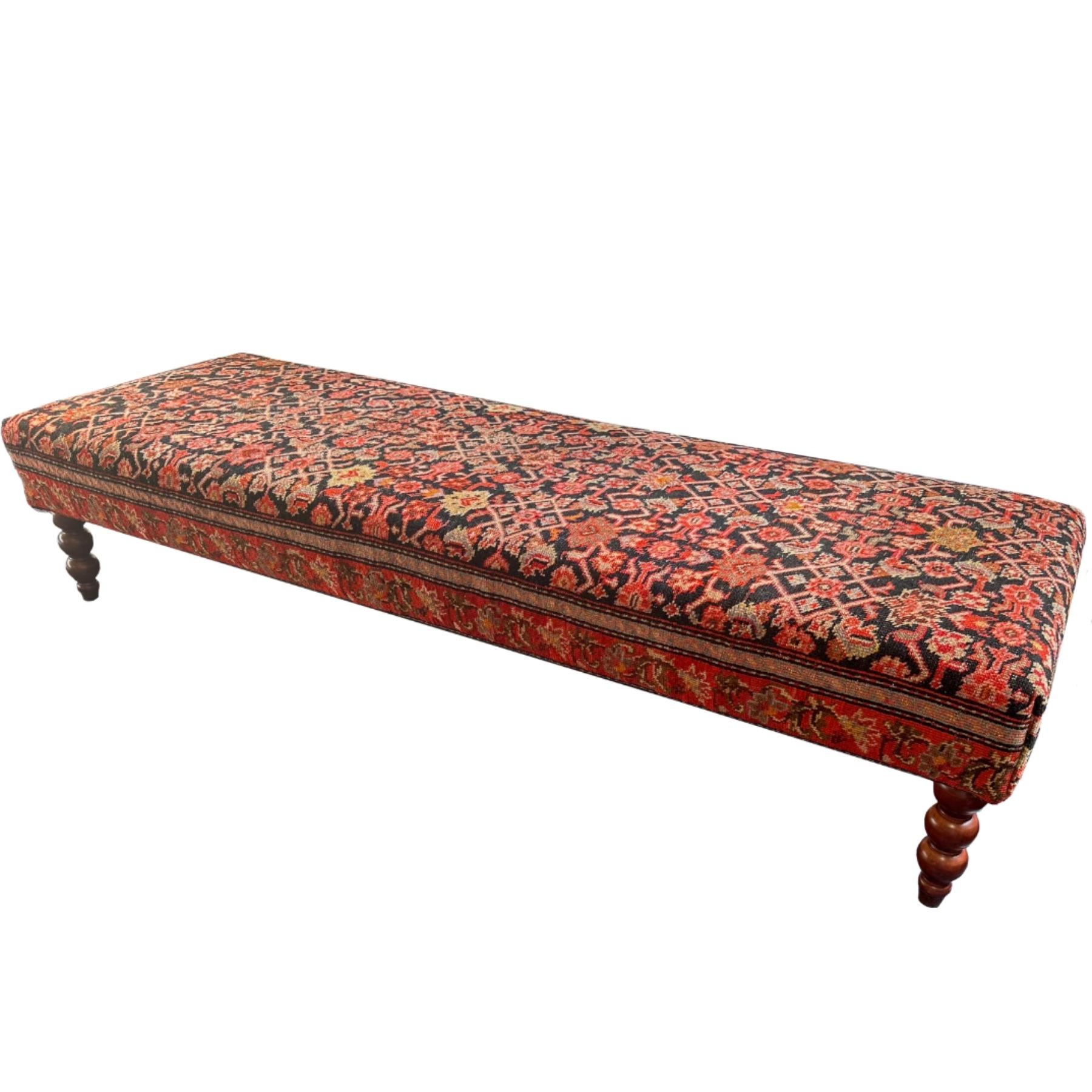 Upholstered in a richly textured, repurposed antique rug, this bench boasts intricate patterns that tell a story. The plush cushion offers both comfort and style, making it perfect as a footrest or a welcoming seat in an entryway, at the end of a
