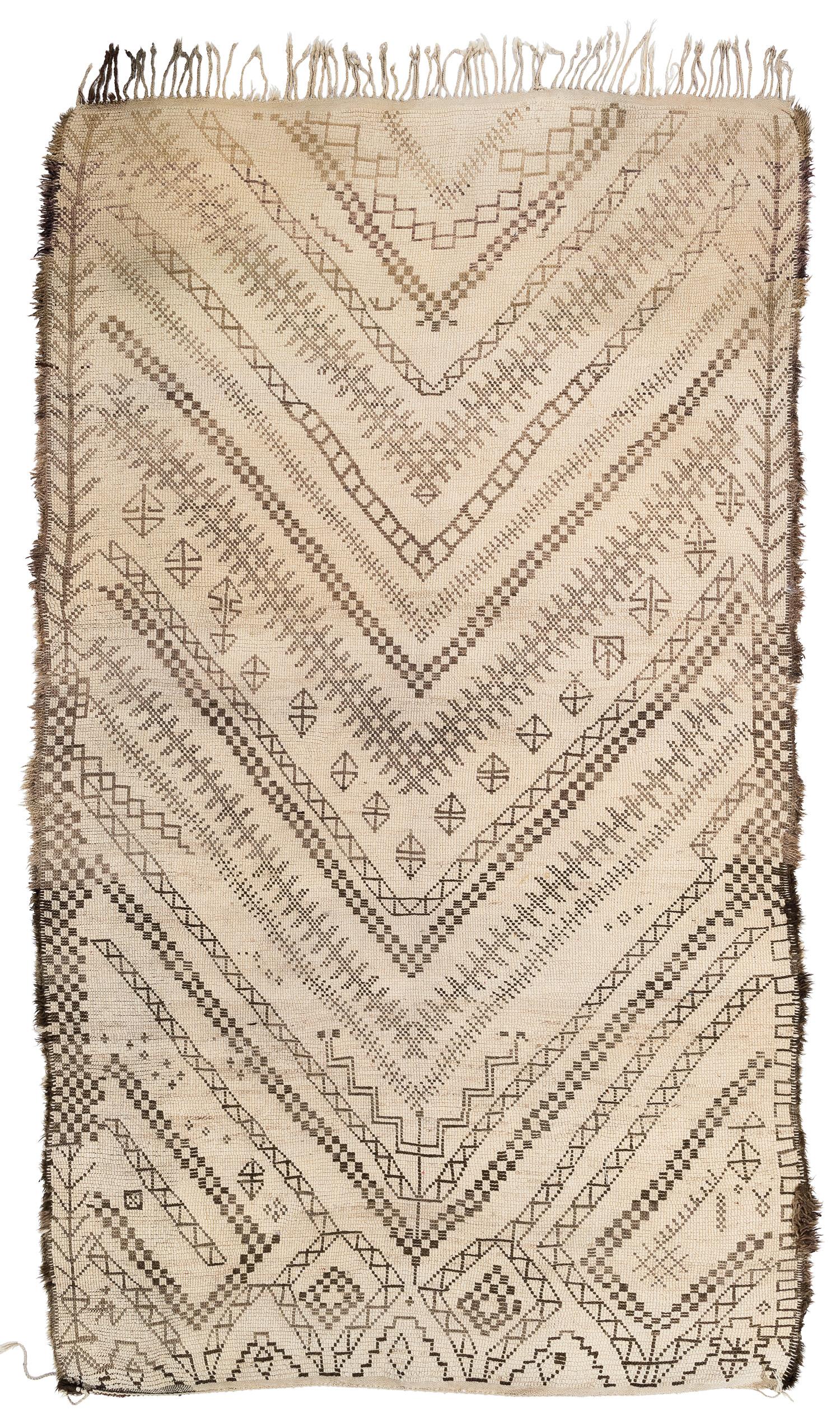 This vintage Moroccan rug is unique in that it has an unusual width of almost 7'. It is very heavy with a dense structure. The pile is quite high and the classic 'V' pattern has a soft contrast in color. It is woven in great wool and very densely