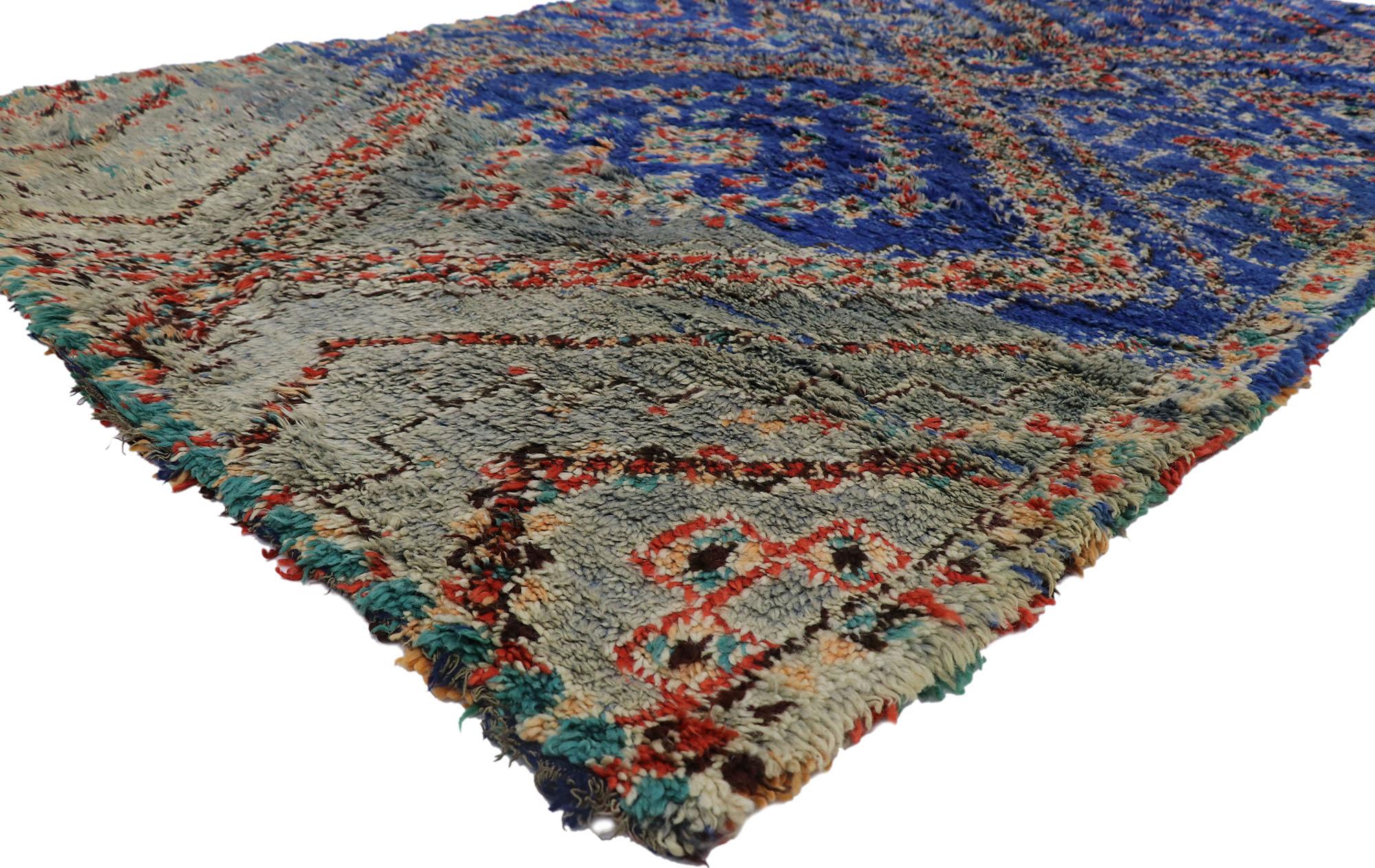 21290 Vintage Beni MGuild Moroccan Rug, 06'02 x 10'06.
Bold boho chic meets Midcentury Modern in this hand-knotted wool vintage Moroccan rug. The distinctive tribal design and lively earth-tone colors woven into this piece work together evoking the