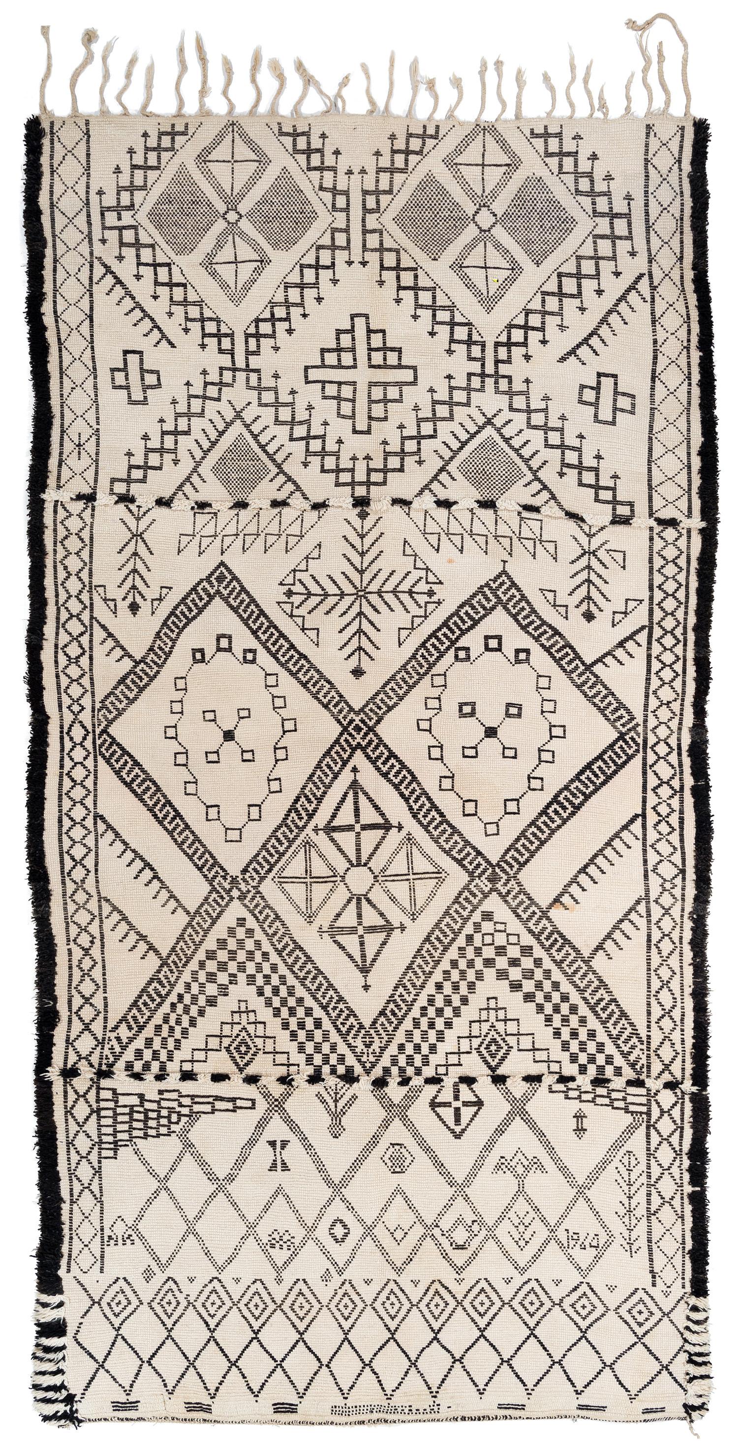 This Beni Ourain has a date of '1964' woven into it that is only visible from the back. it is woven in really good, silky wool It is quite thick and densely woven which gives it a lot of structure. The design is a completely authentic Berber design