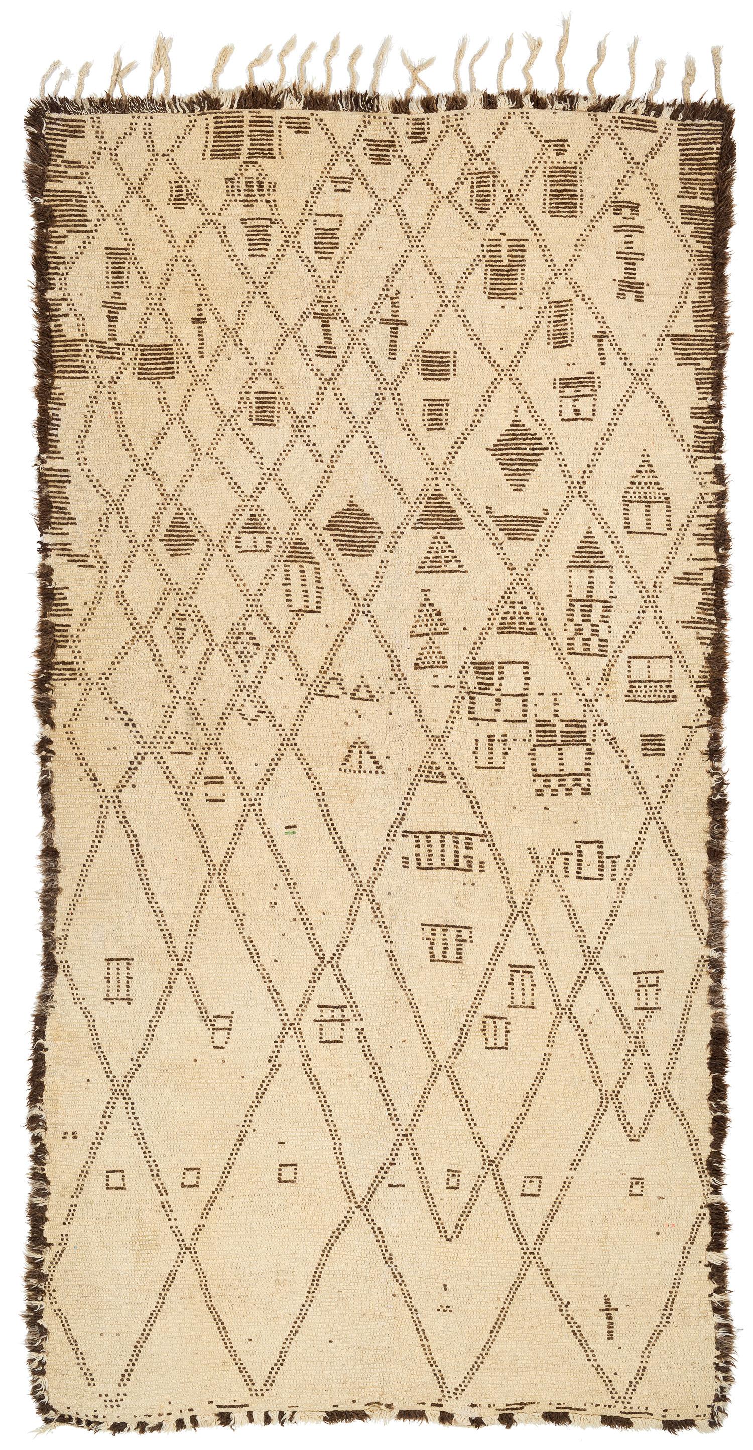 A rare collectible Moroccan antique vintage shag rug. Made by the Beni Ourain tribe in the central middle Atlas mountains. Beautiful natural creamy white wool with natural brown details forming a traditional diamond, crosshatch design. The