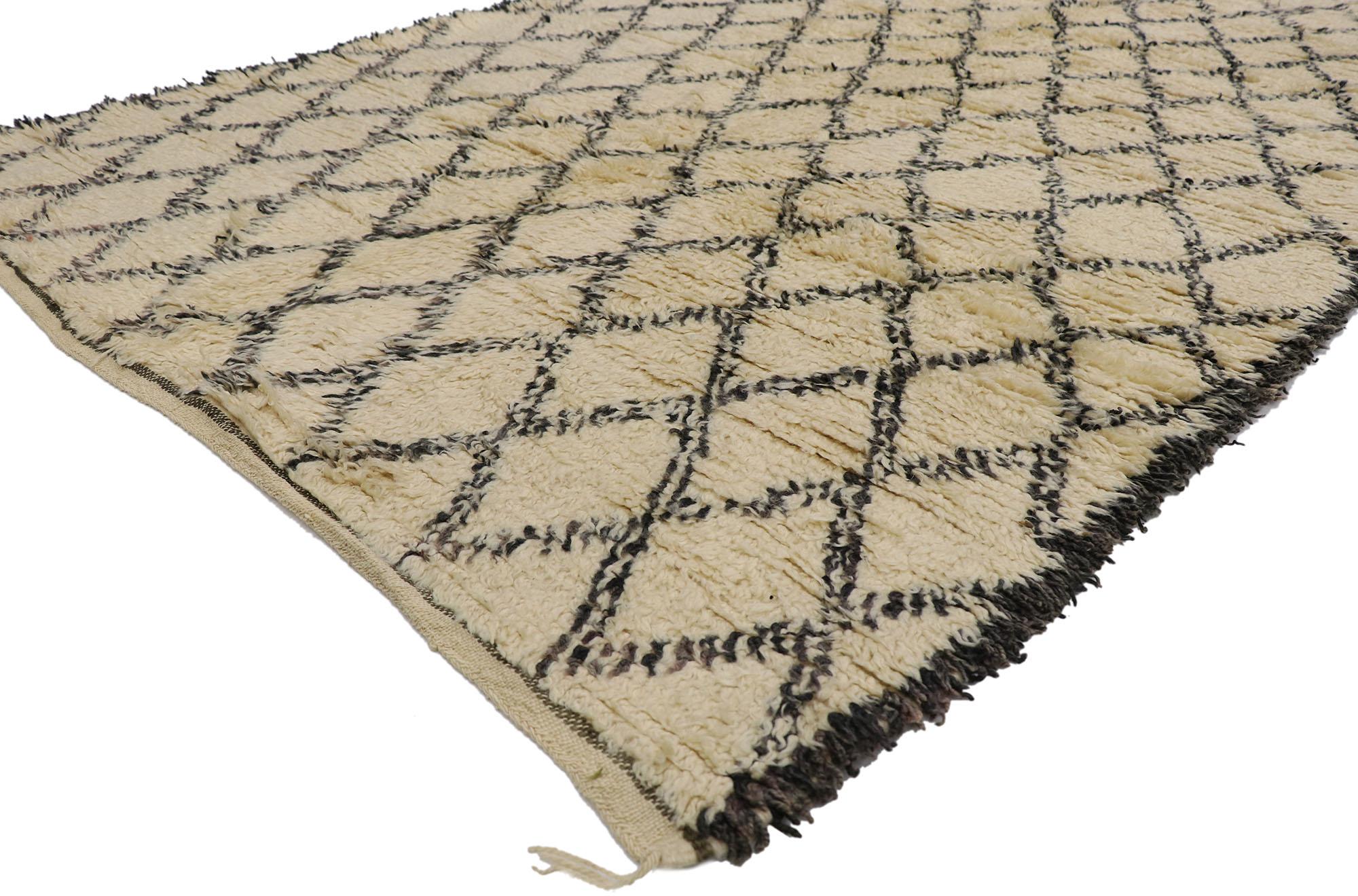21461 Vintage Berber Moroccan Beni Ourain rug. With its simplicity, plush pile and tribal style, this hand knotted wool vintage Berber Beni Ourain Moroccan rug is a captivating vision of woven beauty. It features a diamond lattice composed of lines