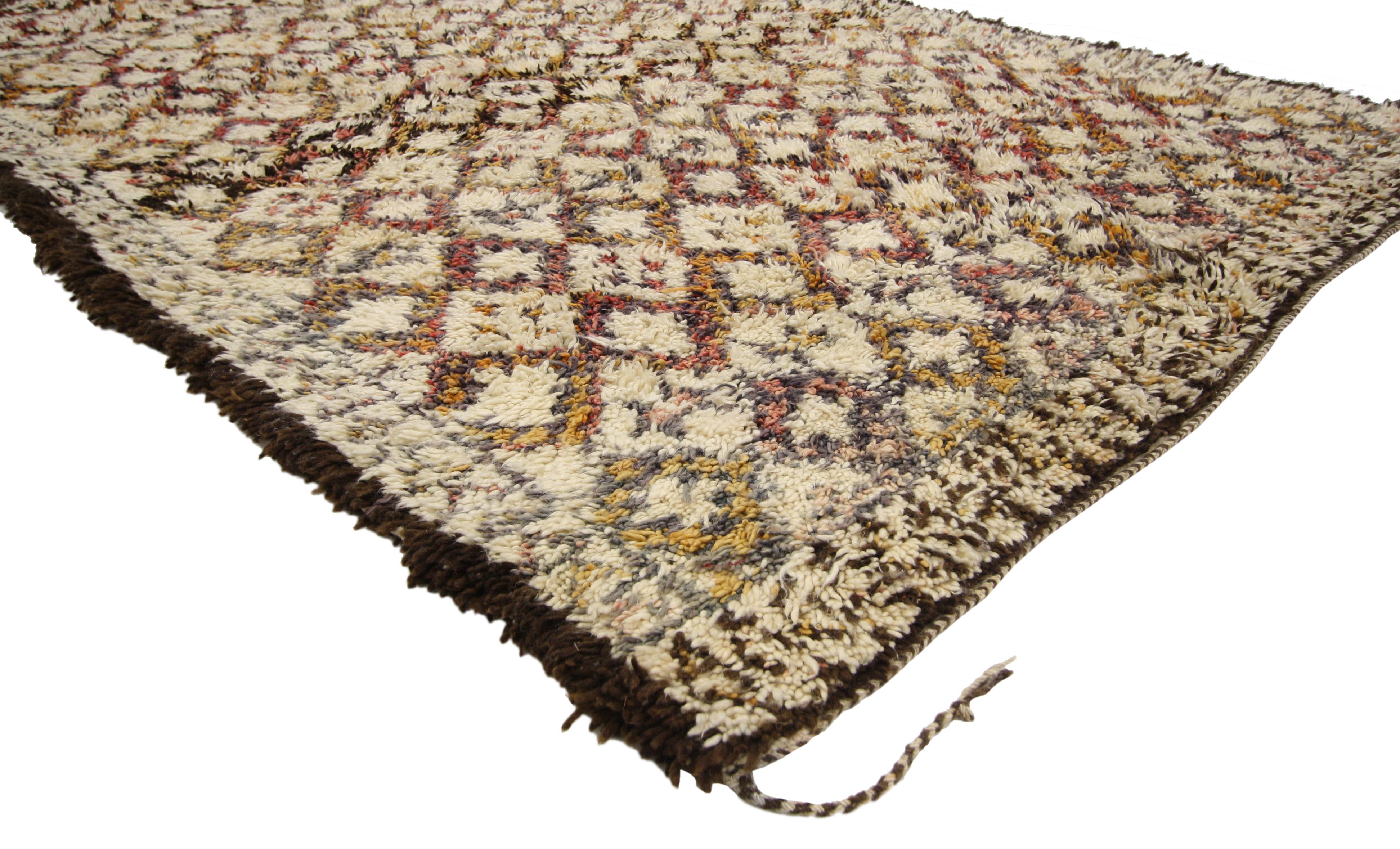 20690 Vintage Moroccan Beni Ourain Rug, 06'04 x 10'03.
Warm worldy charm meets midcentury modern style in this hand-knotted wool vintage Moroccan Beni Ourain rug. The visual complexity and earthy colorway woven into piece work together creating a