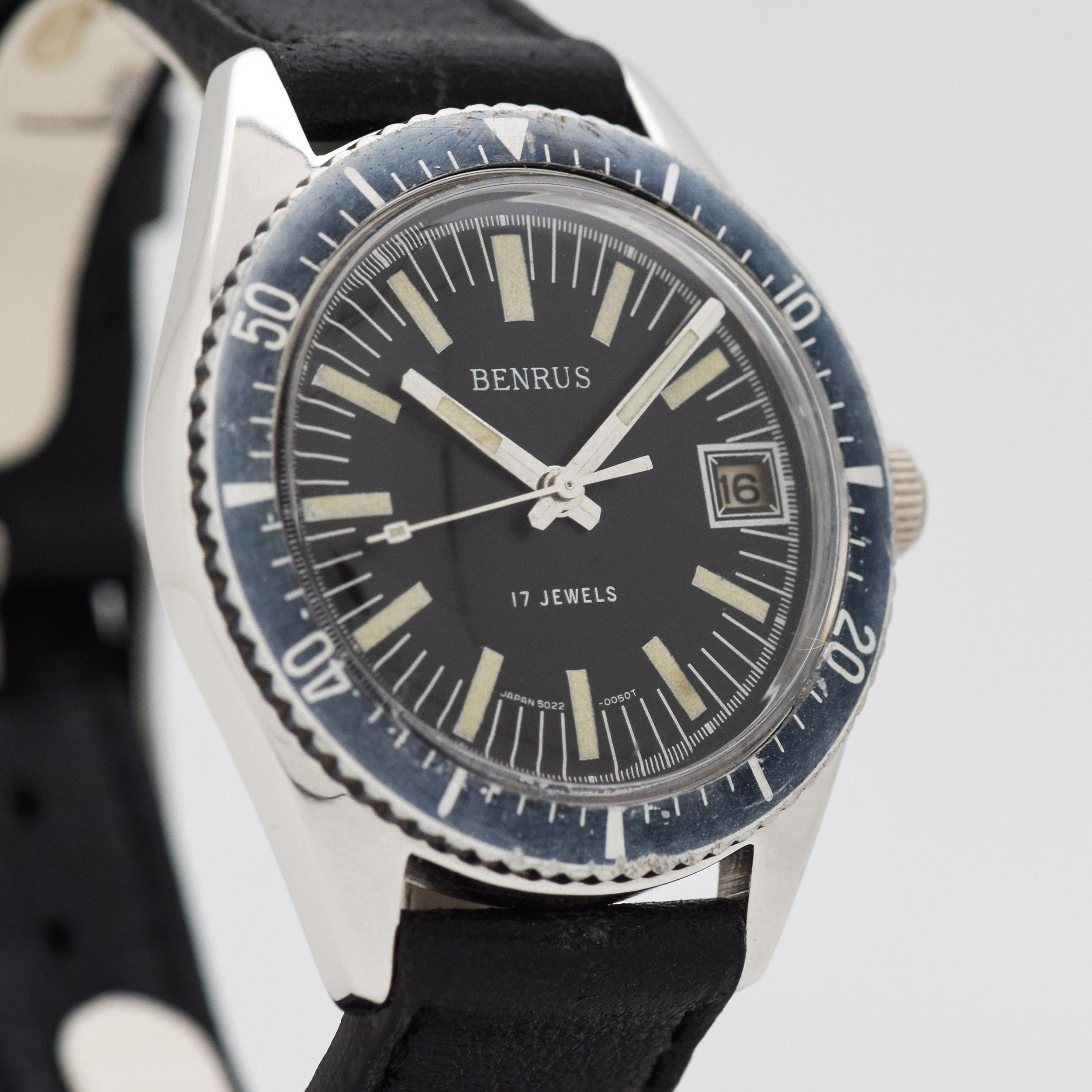 1970's Vintage Benrus Divers Watch. Base Metal & Stainless Steel case, that measures in at 37mm. Original, patinated black dial with luminous, bar markers. Faded, blue diving bezel. Powered by a 17-jewel, manual caliber movement. Equipped with a