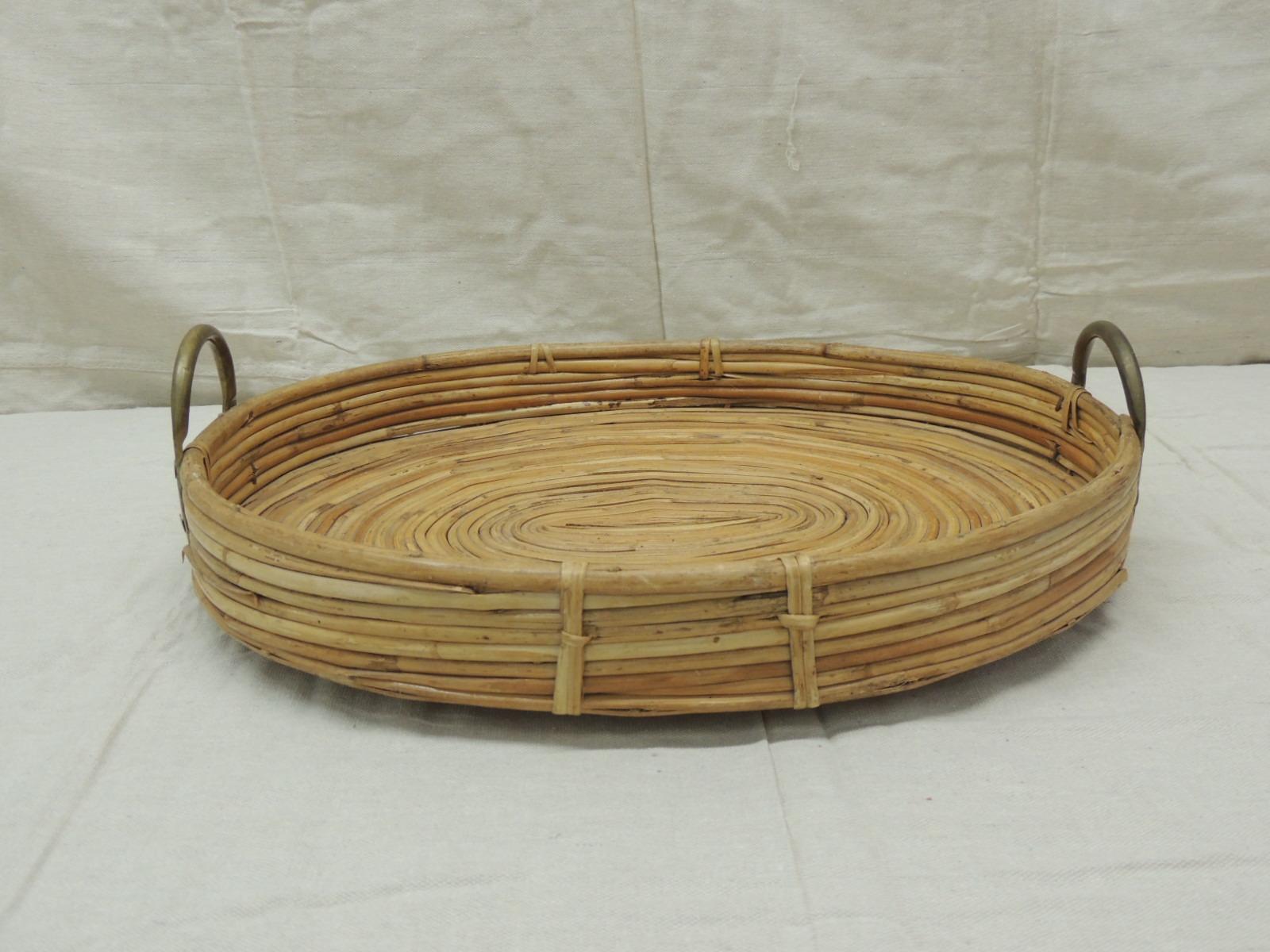 Vintage Bent oval rattan serving tray with antique brass finished handles
Intricate spiral design at the center. Serving tray in honey color.
Hand made in India
Size: 19