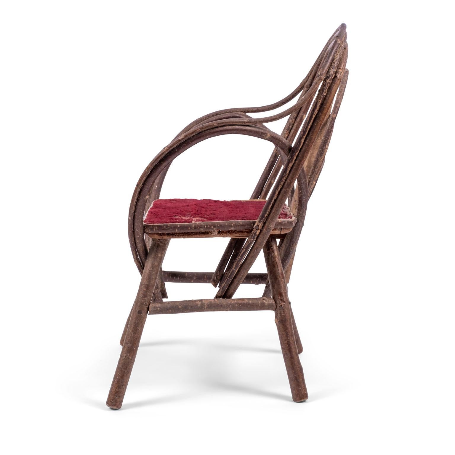 Vintage petite bent-willow chair, circa 1910s-1930s. Small Folk Art chair made from bent willow featuring original red velvet upholstered seat (seat can be reupholstered for a nominal cost). Perfect size for a small child, large doll or as a