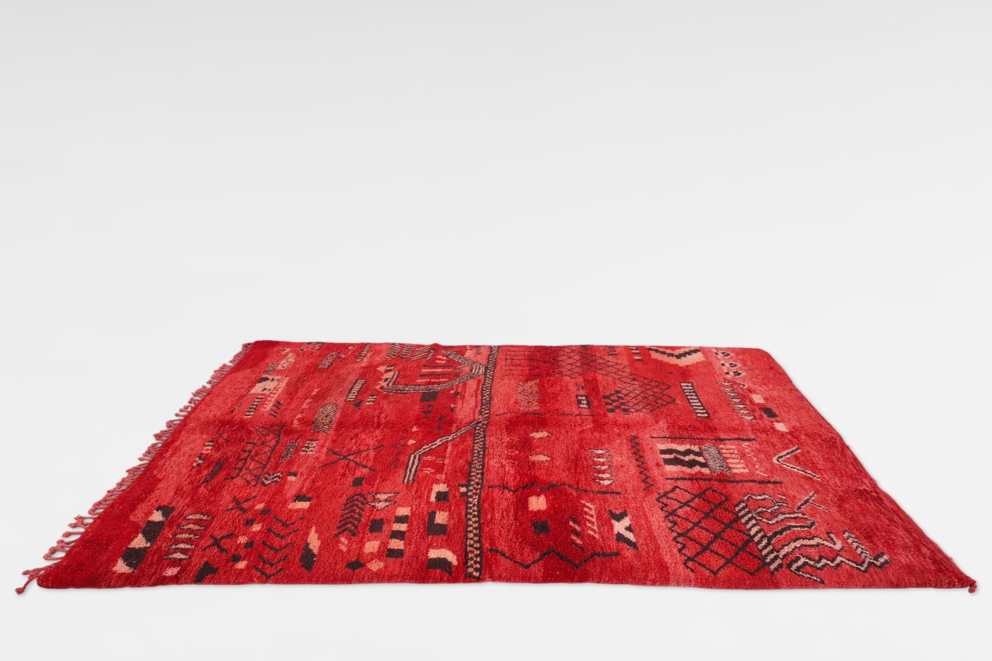 Vintage red Beni Mrirt Moroccan Rug, a timeless symbol of Moroccan weaving tradition. Crafted by skilled artisans of the Beni Mrirt tribe nestled in Morocco's Atlas Mountains, these rugs boast sumptuous texture, geometric designs, and serene earthy