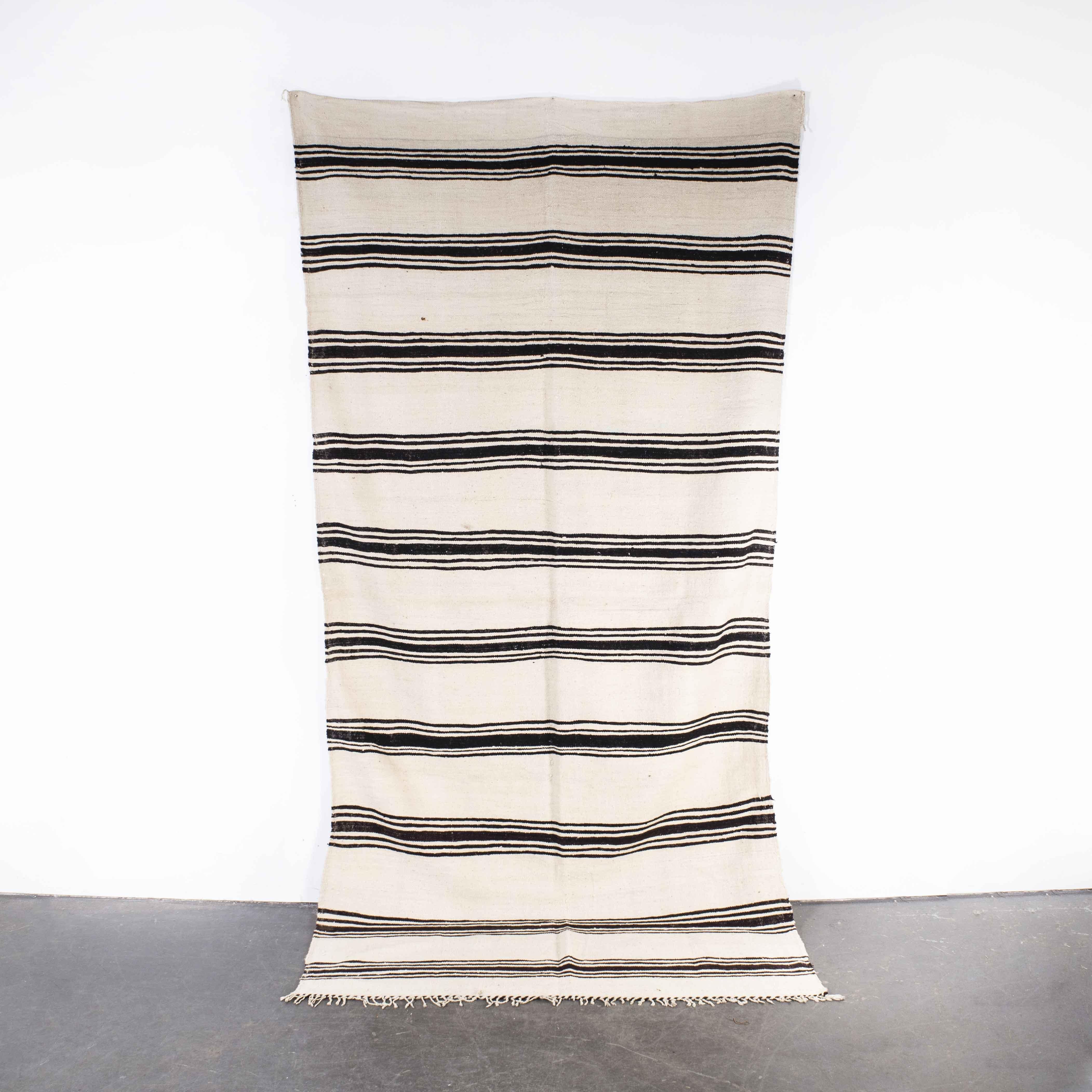 Vintage Berber Bold Monochrome Stripe Hanbel Rug
Vintage Berber Bold Monochrome Stripe Hanbel Rug. These are flat-woven rugs (Hanbel in Arabic) which are light in weight due to the lack of pile. They are often used on floors in hotter countries as