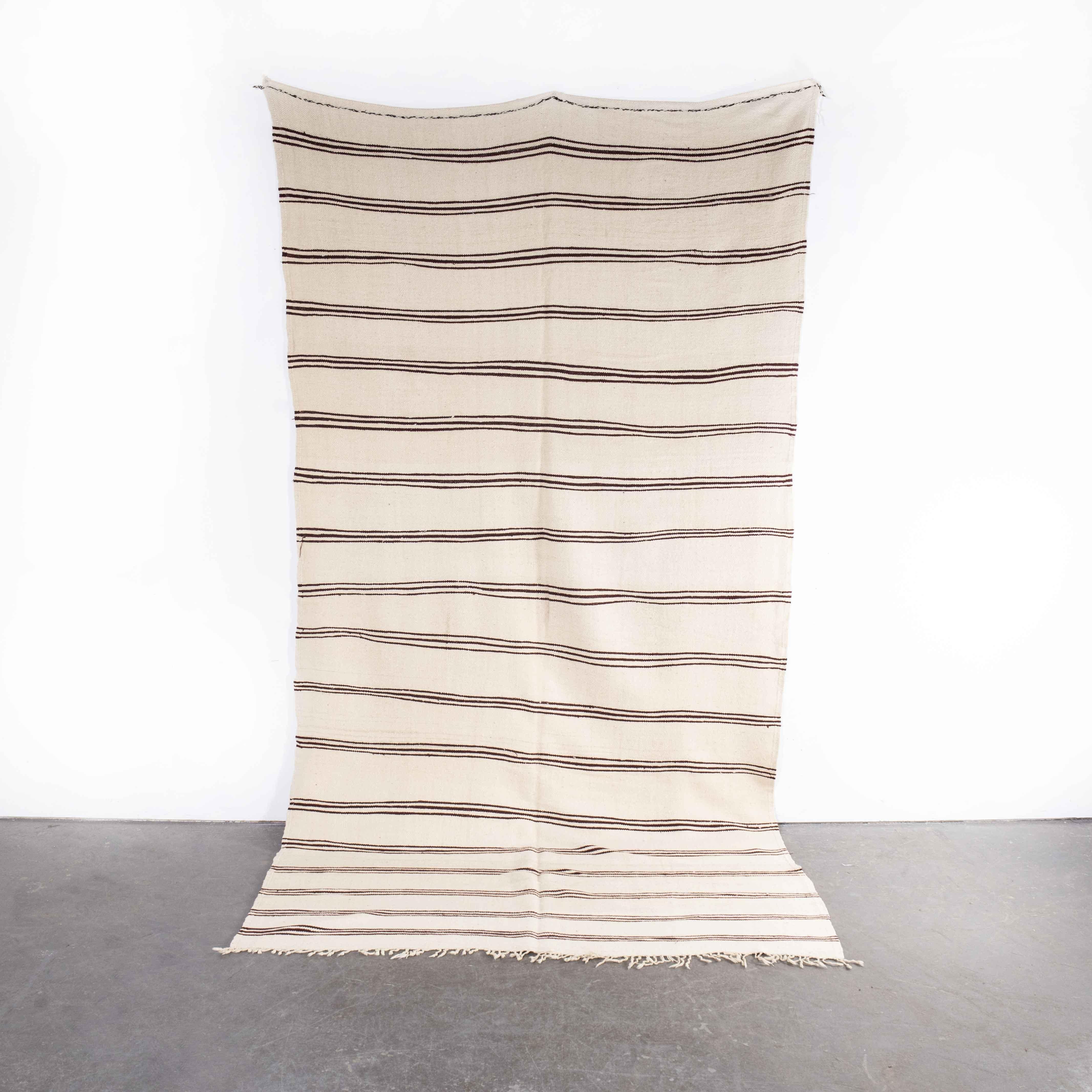 Vintage Berber bold monochrome thin stripe hanbel rug
Vintage Berber bold monochrome thin stripe hanbel rug. These are flat-woven rugs (Hanbel in Arabic) which are light in weight due to the lack of pile. They are often used on floors in hotter