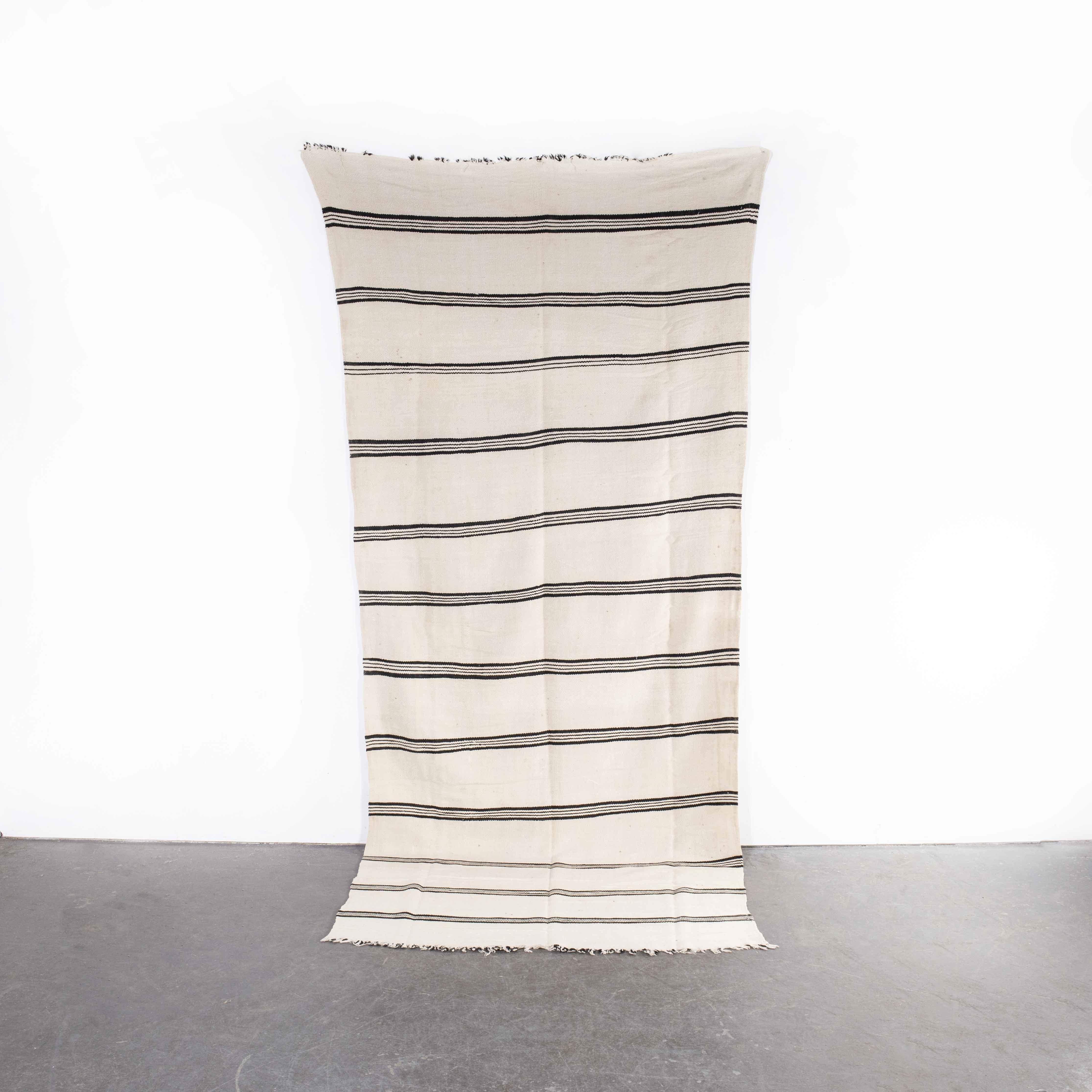 Vintage Berber Bold Monochrome Twin Stripe Hanbel Rug
Vintage Berber Bold Monochrome Twin Stripe Hanbel Rug. These are flat-woven rugs (Hanbel in Arabic) which are light in weight due to the lack of pile. They are often used on floors in hotter