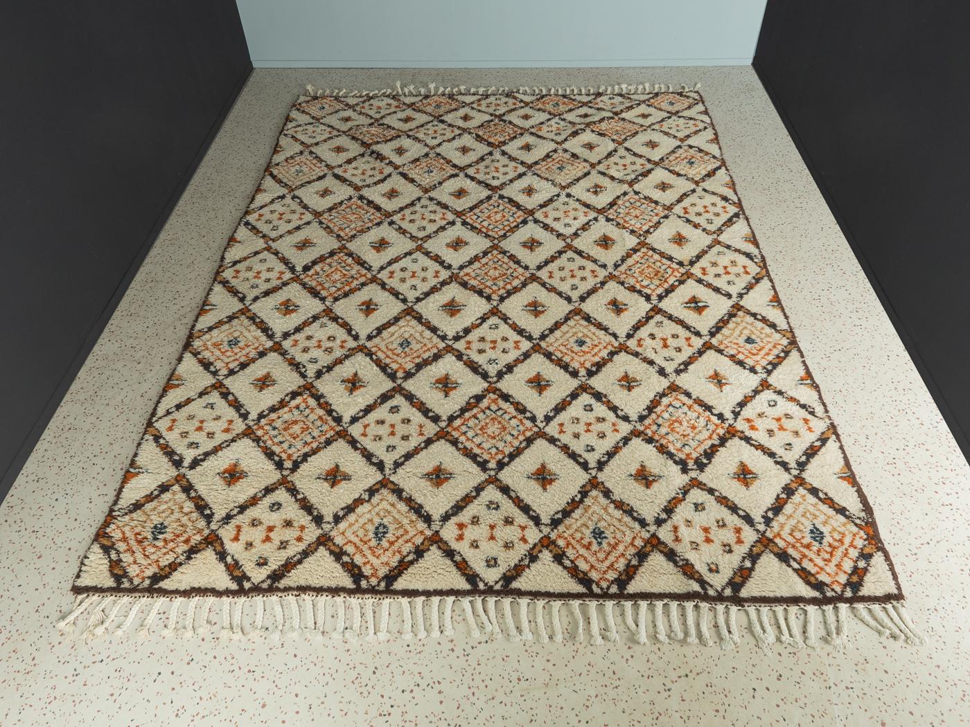 Wonderful Berber carpet from the 1960s. High-quality creamy white pile with diamond patterns in earth tones.

Quality Features:
 Berber carpet
 Hand knotted
 approx.40,000 knots per m2
 50-60 years old
 100% wool
 Made in Morocco

All of