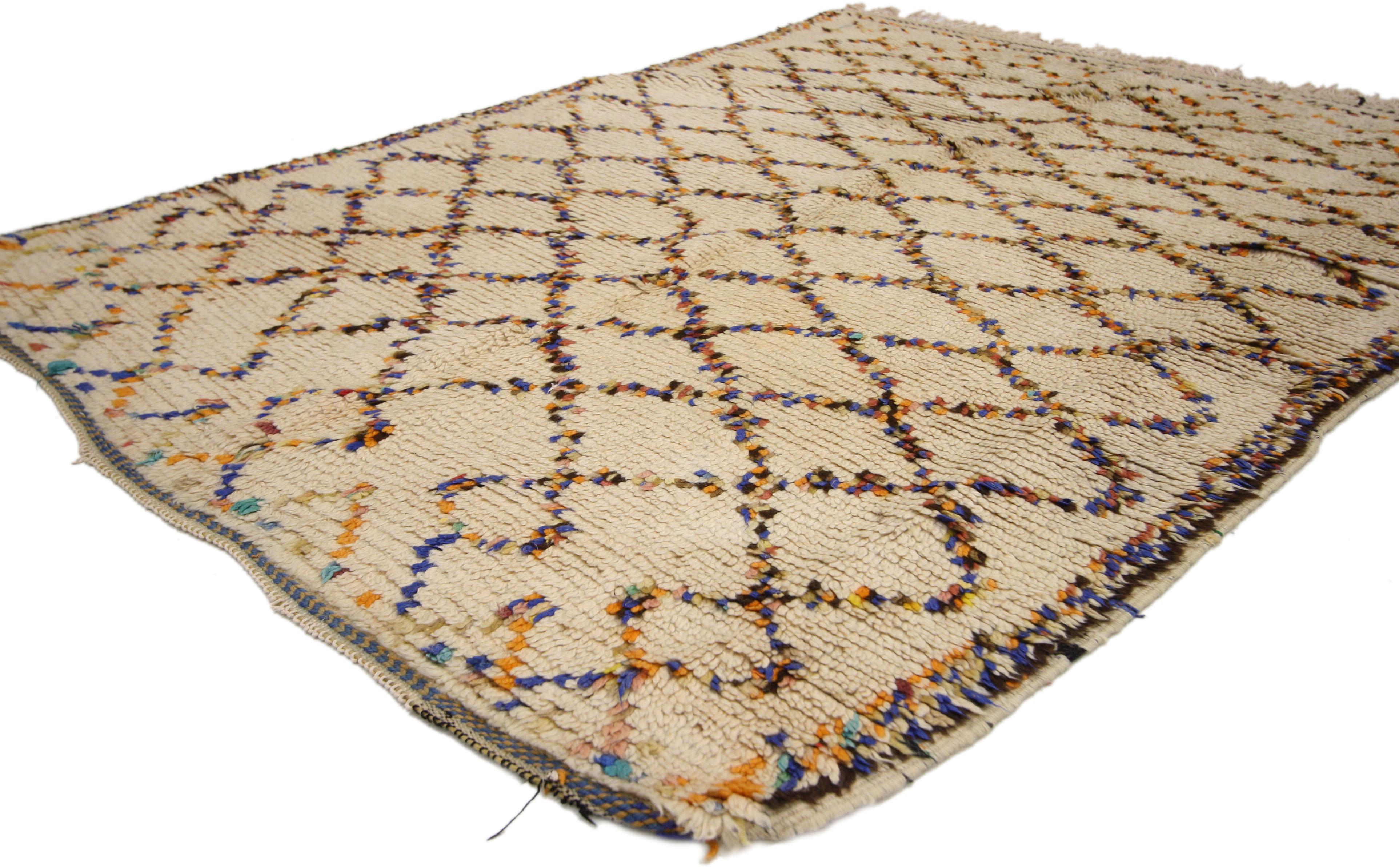 74545 vintage Berber Moroccan Azilal rug with Tribal style, colorful Moroccan rug. A creamy beige field with colorful lines creates an eccentric lozenge trellis pattern that can perfectly tie together eclectic interiors. This subtle rainbow and