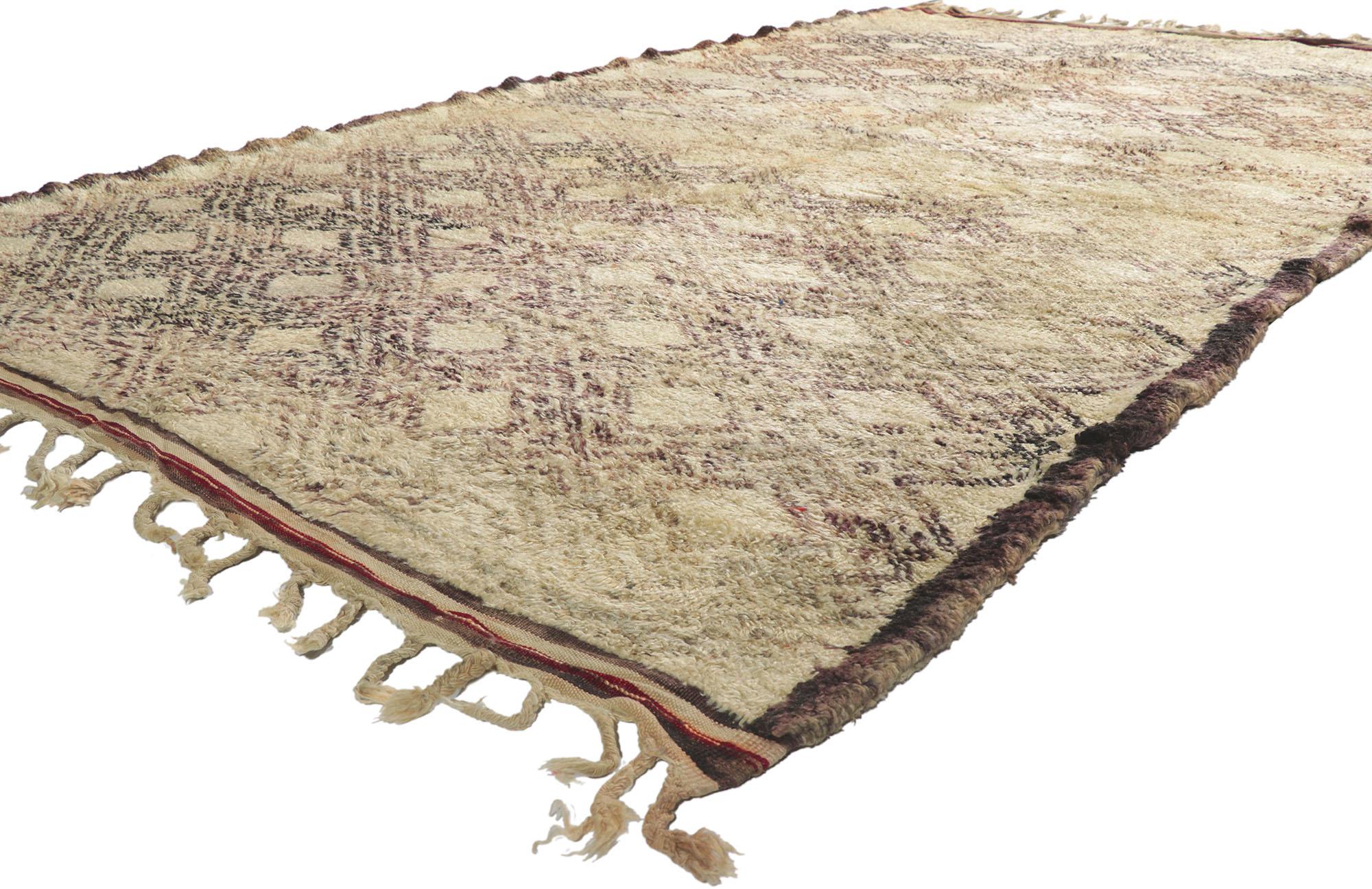 21397 Vintage Berber Moroccan Beni Ourain Rug. With its simplicity, plush pile and tribal style, this hand knotted wool vintage Berber Beni Ourain Moroccan rug is a captivating vision of woven beauty. It features a diamond lattice composed of lines