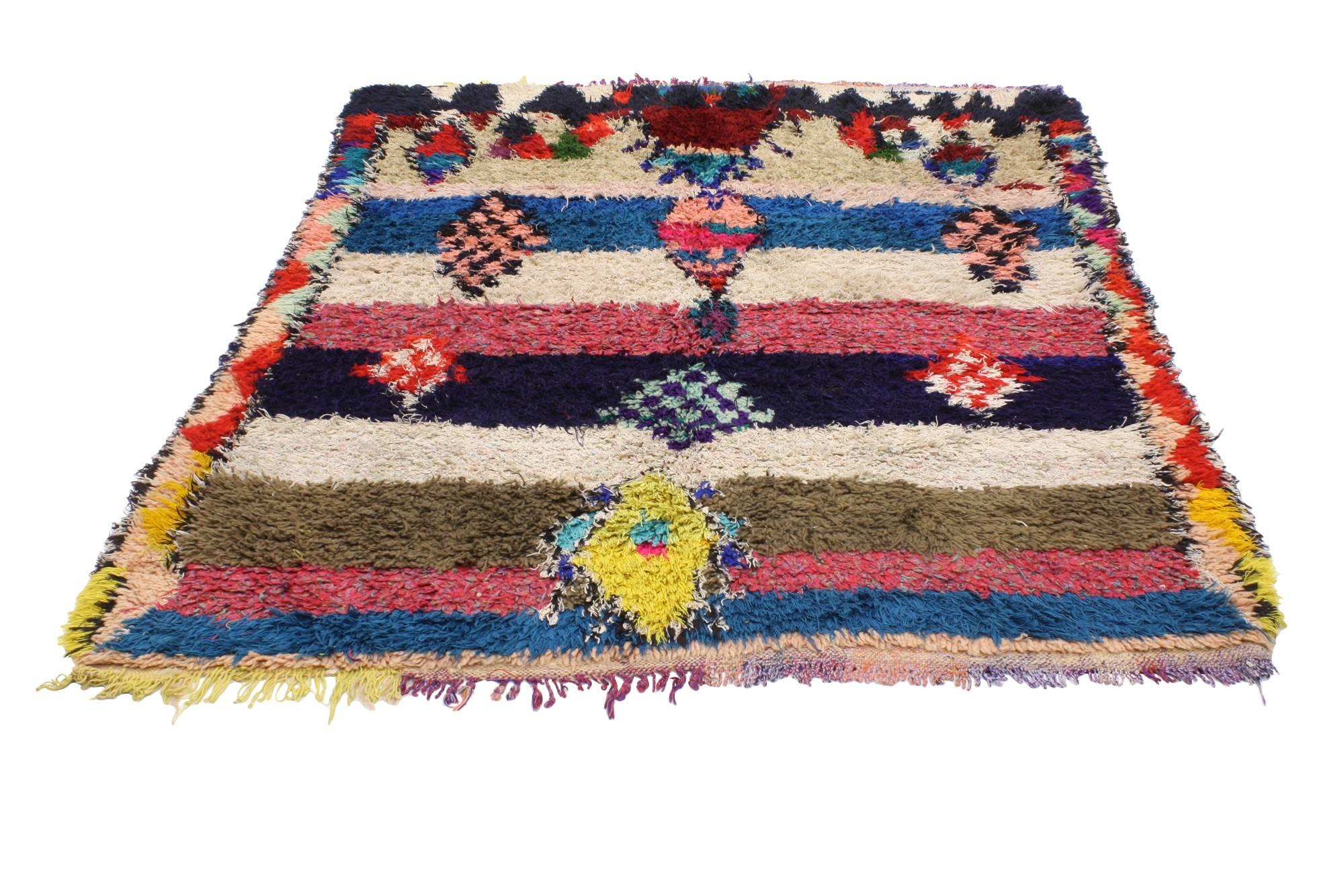 20485, vintage Berber Moroccan Boucherouite rug. Stark shades of the colors woven into this piece work together to create a contemporary abstract look. The variegated color pattern conjures the tribal feeling of Moroccan spirit in this Vintage
