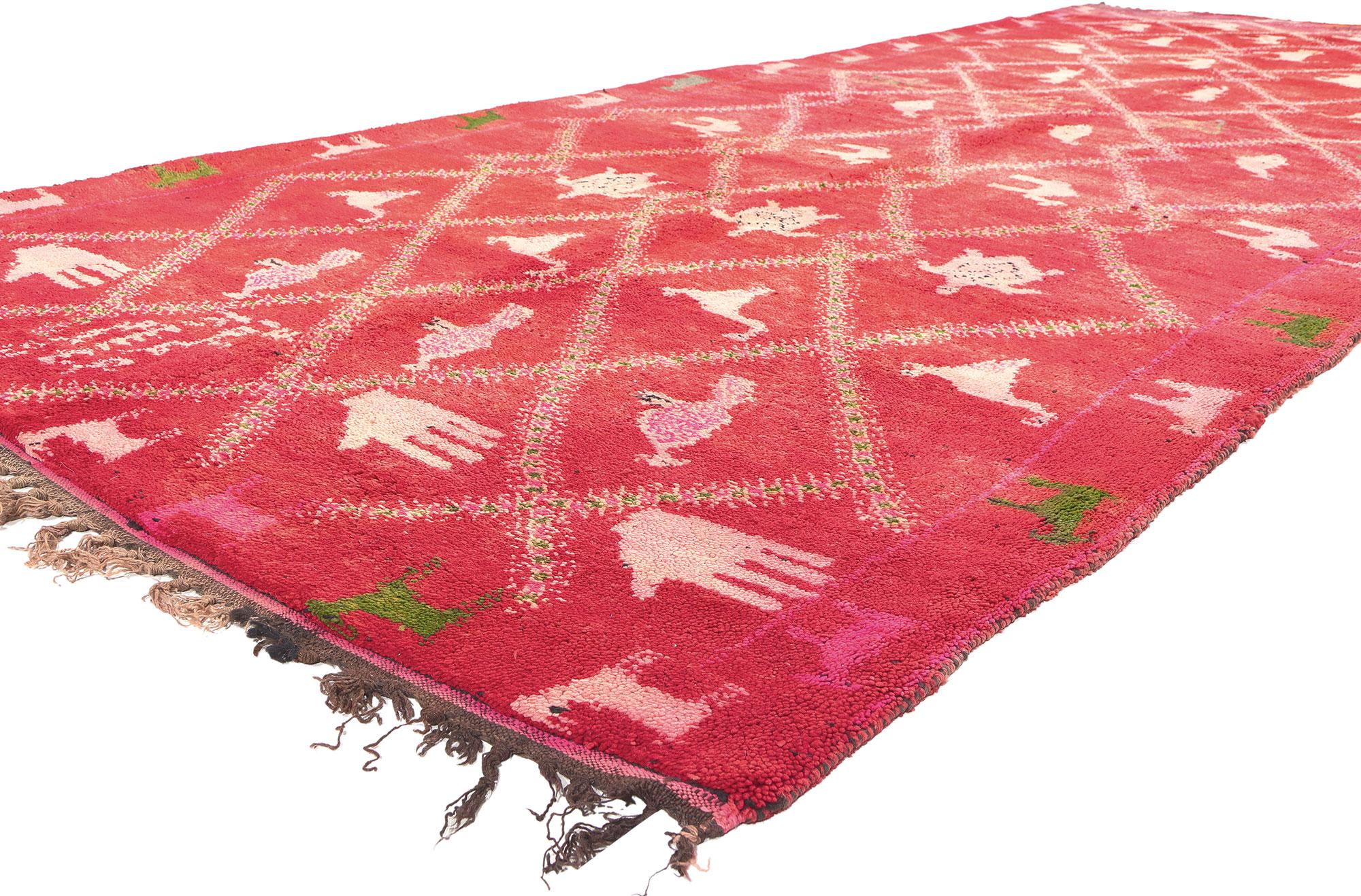 20358 Vintage Red Moroccan Rug, 06'00 x 14'05.

Immerse yourself in the captivating allure of this hand knotted wool vintage Berber red Moroccan rug, where a tapestry of animals and handprints unfolds within an enchanting lozenge trellis. The