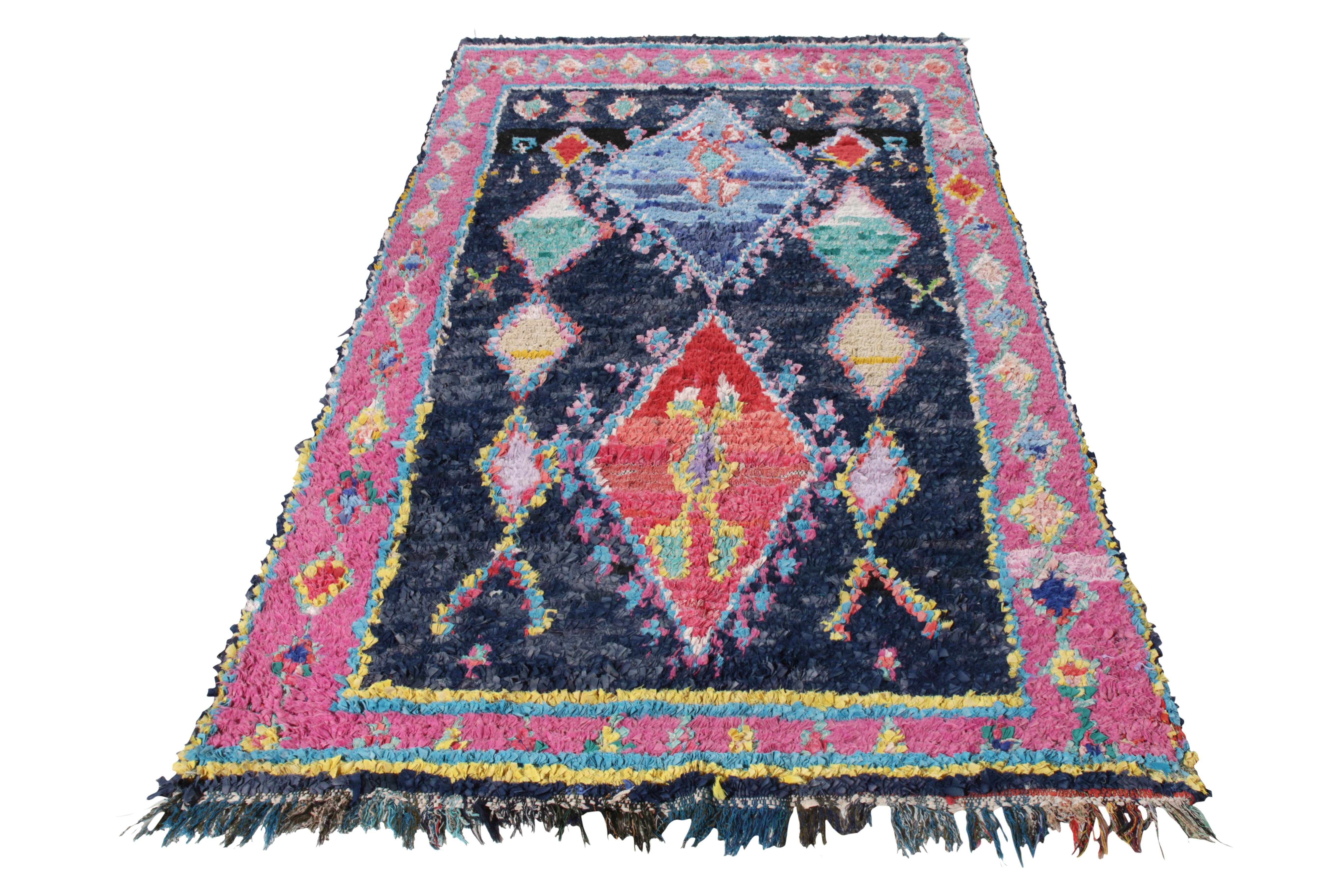 Originating from Morocco circa 1950-1960, a vintage Berber Kilim from Rug & Kilim’s titular Moroccan rug collection. Hand-knotted in Boucherouite fabric and wool fibres, this 5x9 piece is a concoction of pile and flat weave - making it a rare piece
