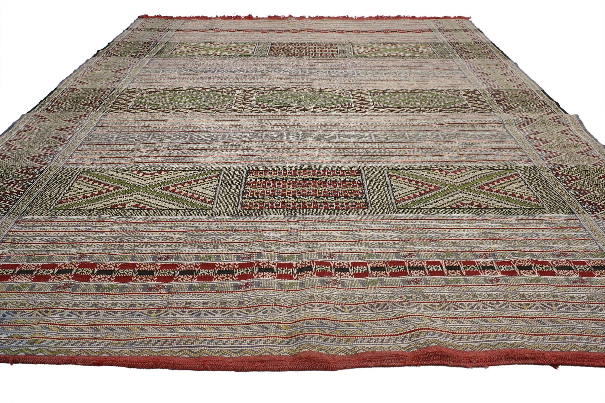77008, muted tones of red, tan, beige, cream, green, grey and black provide a beautiful color scheme for the intricate design featured on this vintage Berber Moroccan Kilim rug. This piece is rich in ancient Berber culture, as the design displays a