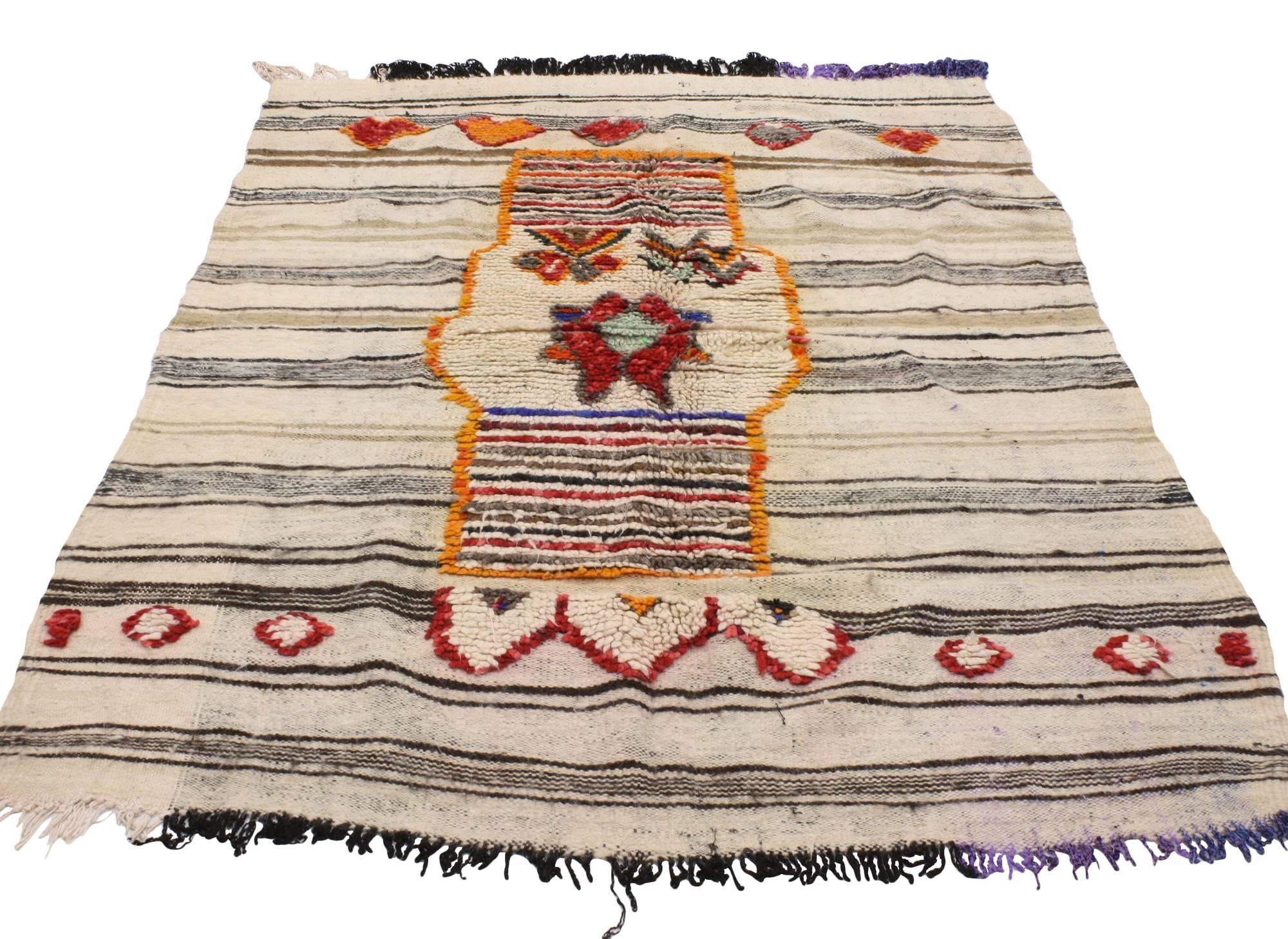 20456, vintage Berber Moroccan Kilim rug. Creamy beige sets the stage for earth-tone horizontal stripes and vibrant tribal design. The stark contrast of the red and orange colors woven into this vintage Berber Moroccan Kilim rug create a unique