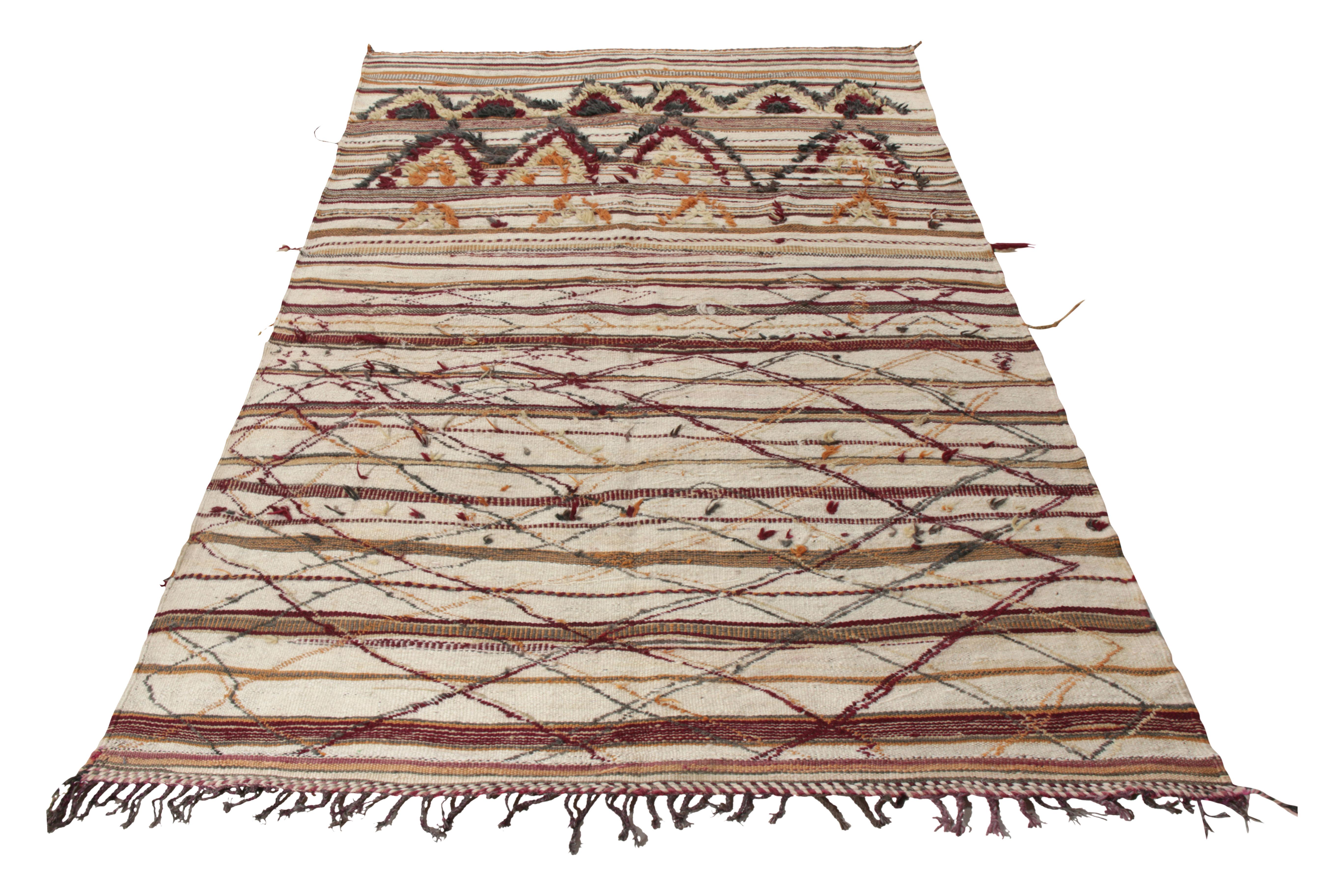 Handwoven in wool circa 1950-1960, a vintage Moroccan Berber Kilim rug joining Rug & Kilim’s titular collection. Covering a 6x10 size of unique textural sensibility, the rug witnesses a dynamic geometric pattern in beige-brown while carrying raw