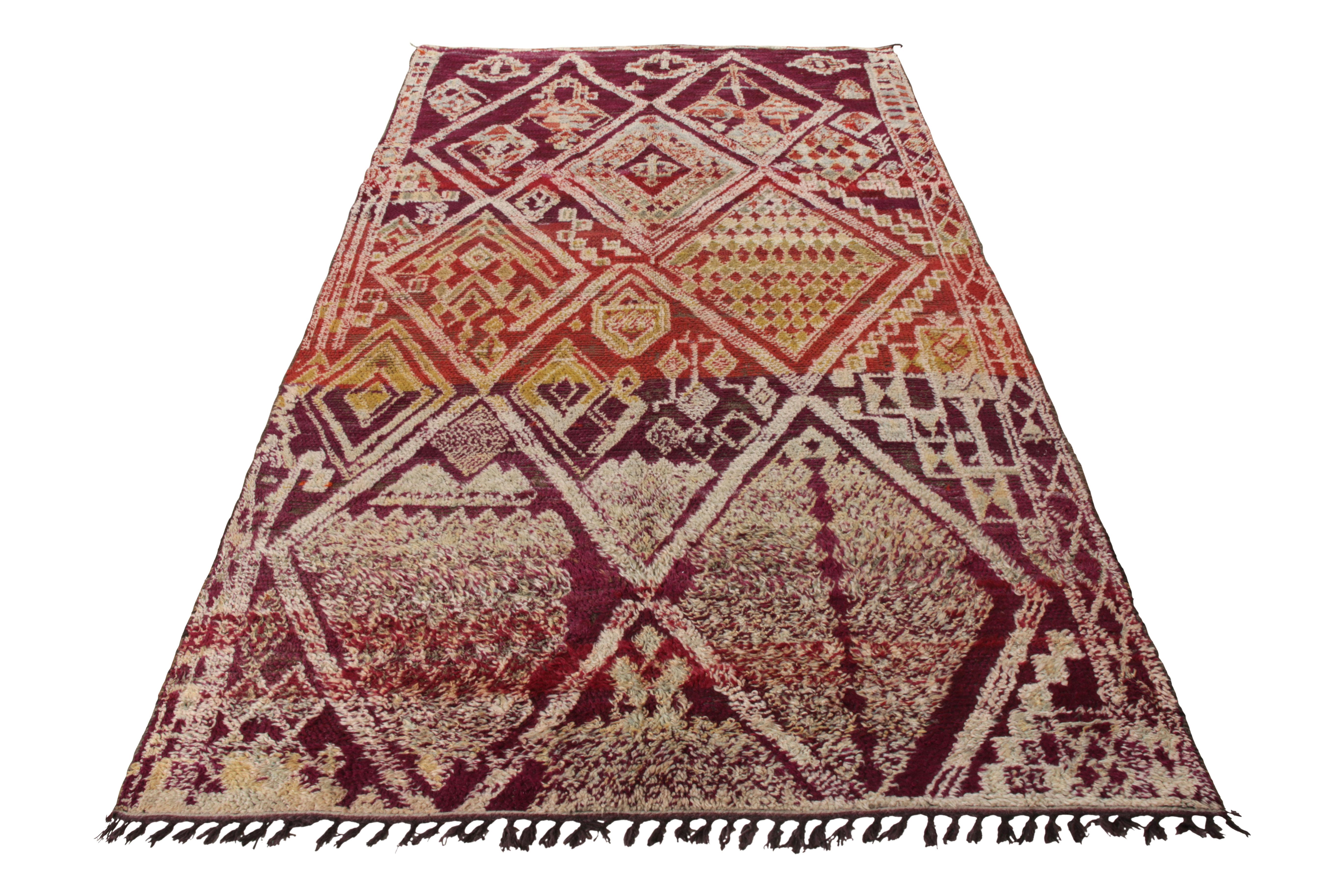 Hand-knotted in wool circa 1950-1960, a vintage Moroccan Berber rug joining Rug & Kilim’s Antique & Vintage Collection. Featuring a gorgeously rich, uniquely defined, sharp geometric pattern in red, white and green, the rug boasts a creative