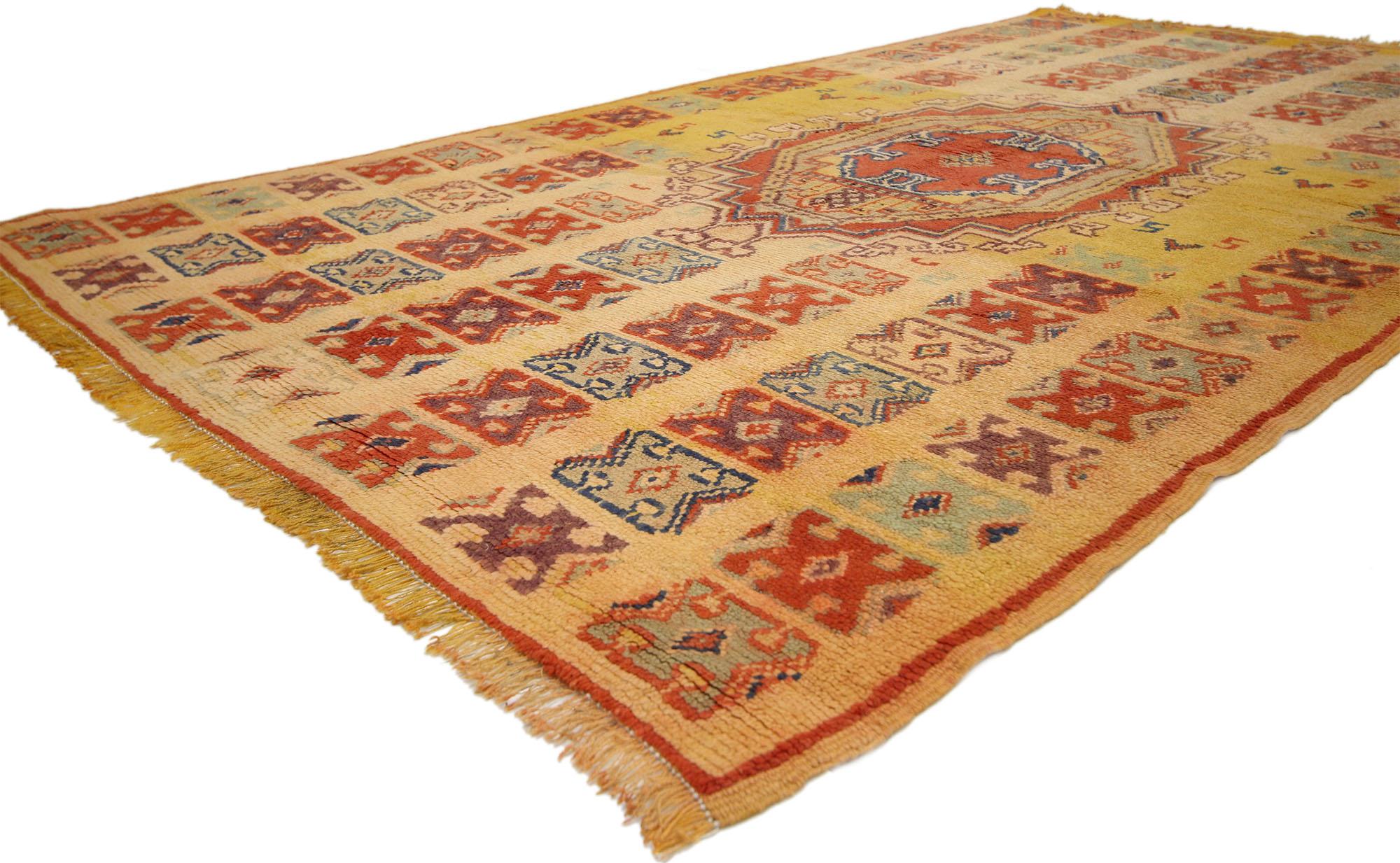 74555, vintage Berber Moroccan rug in traditional style. Muted shades of orange and saffron provide a beautiful backdrop for the colorful tribal motifs that overlay this Vintage Berber Moroccan rug. More than the symmetrical beauty found in the