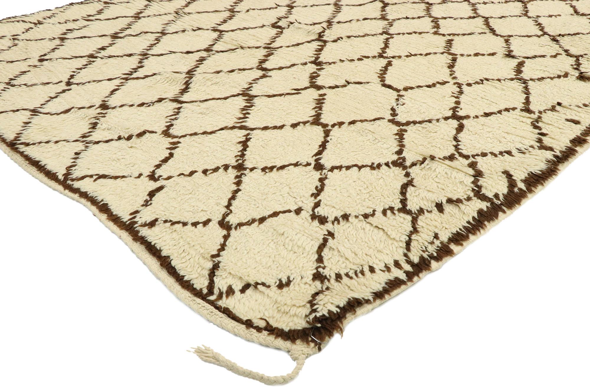 74830, vintage Berber Moroccan rug with modern style. This hand knotted wool vintage Moroccan rug features contrasting dark brown lines running the length of the beige field. The asymmetrical lines criss cross in an organic manner, creating a