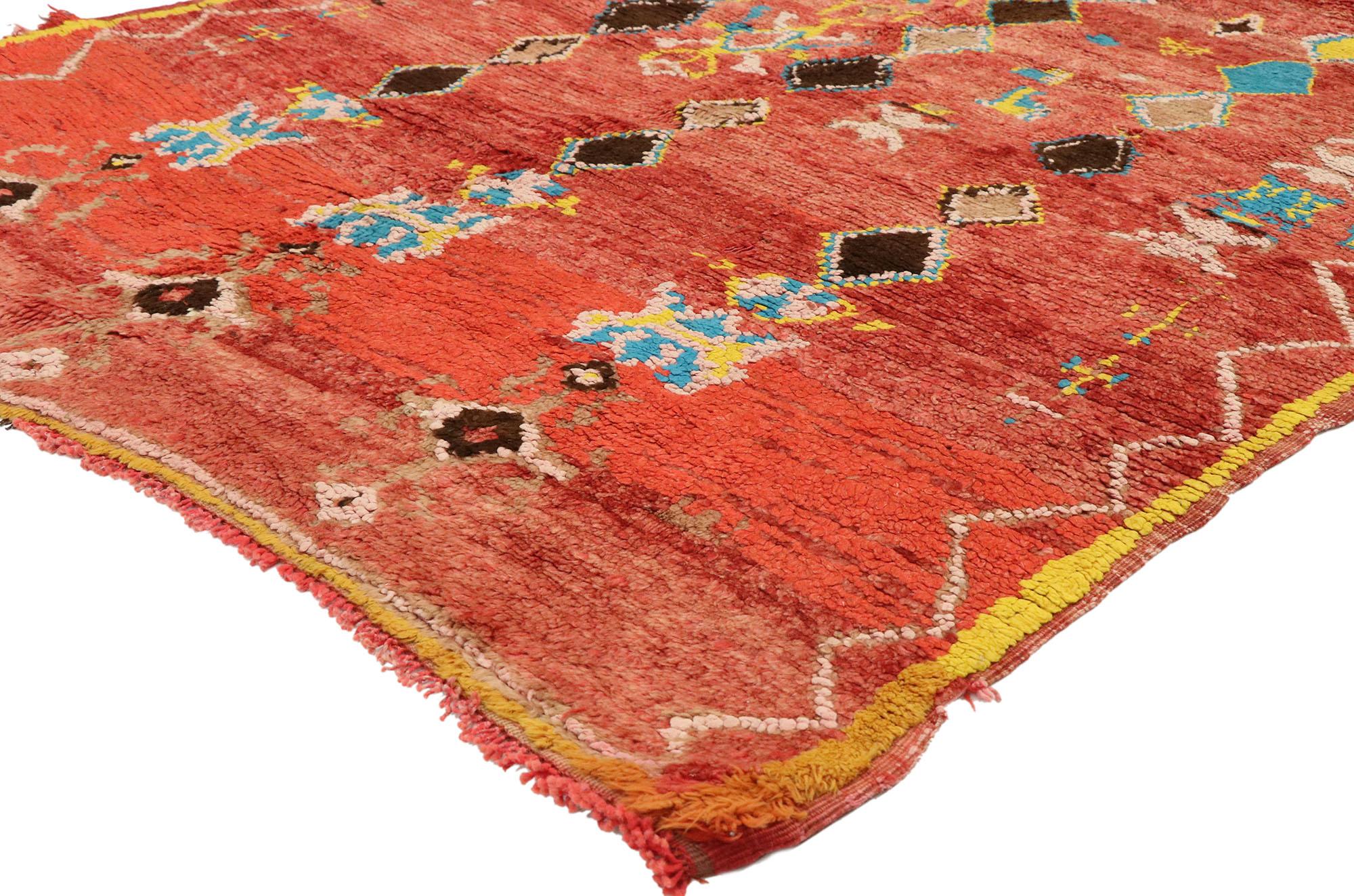20086, vintage Berber Moroccan rug with Postmodern Tribal style. This hand knotted vintage Moroccan rug features an all-over geometric pattern composed of polychromatic tribal motifs spread across an abrashed red field. Three rows of colorful and