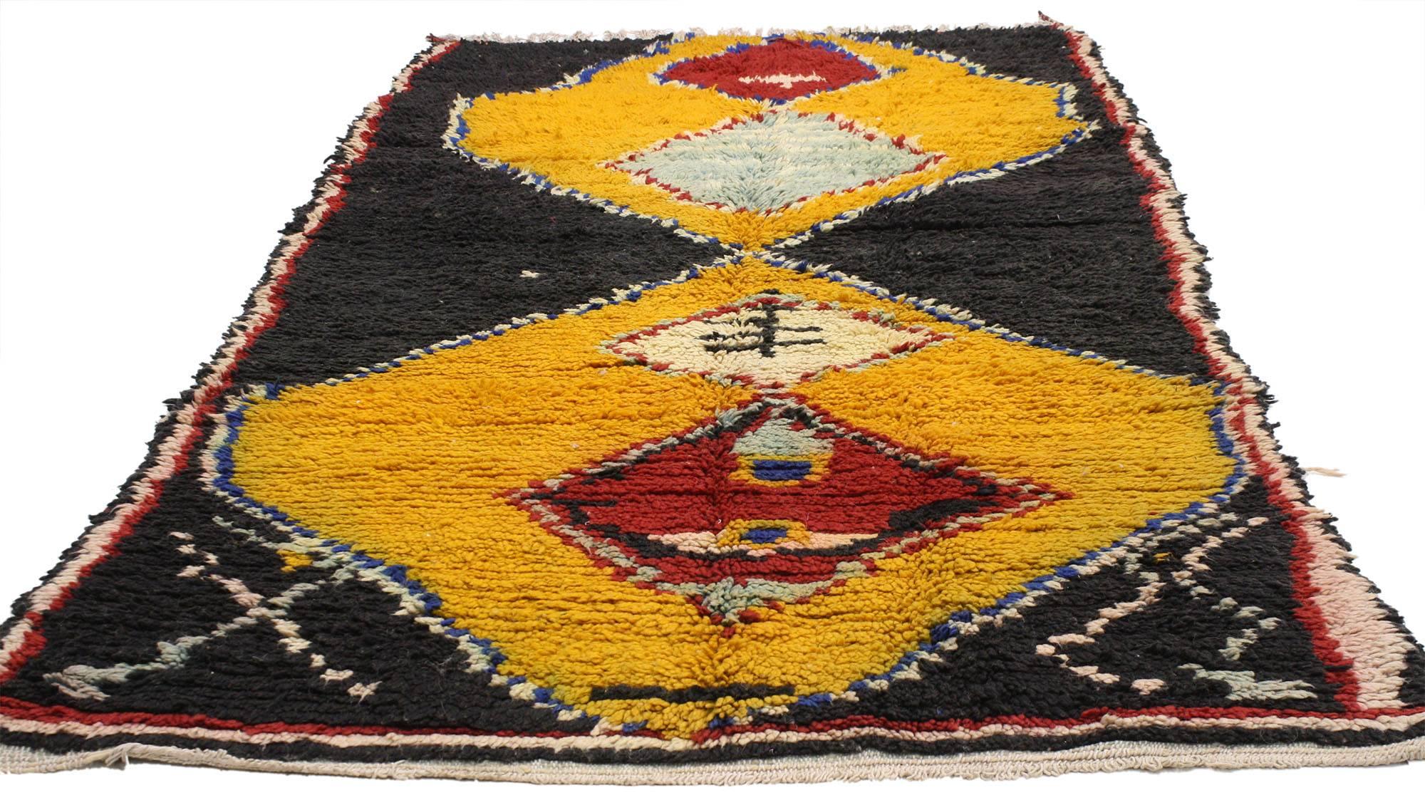 20583 vintage Berber Moroccan rug with tribal style. Jet black sets the stage for diamonds colored in intense shades of yellow and red. The stark contrast of the colors woven into this vintage Berber Moroccan rug creates a unique piece to add zest