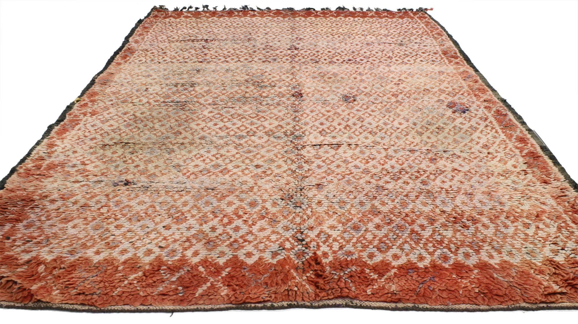 20612 vintage Berber Moroccan rug with tribal style. This vintage Berber Moroccan rug is colored with the power of crimson and umber, colors which denote the rich culture of the ancient Berbers. Creamy beige overlays the centre of the rug, forming