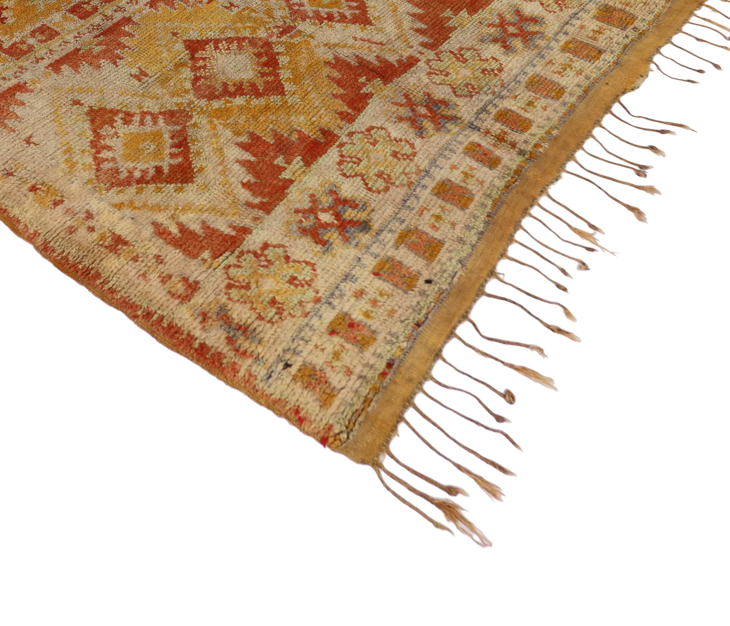 74561, vintage Berber Moroccan rug with tribal style. Rendered in variegated shades of rustic red, burnt orange and saffron come together to create imagery of a warm, breezy Moroccan sunset. The time-softened colors blend together throughout the