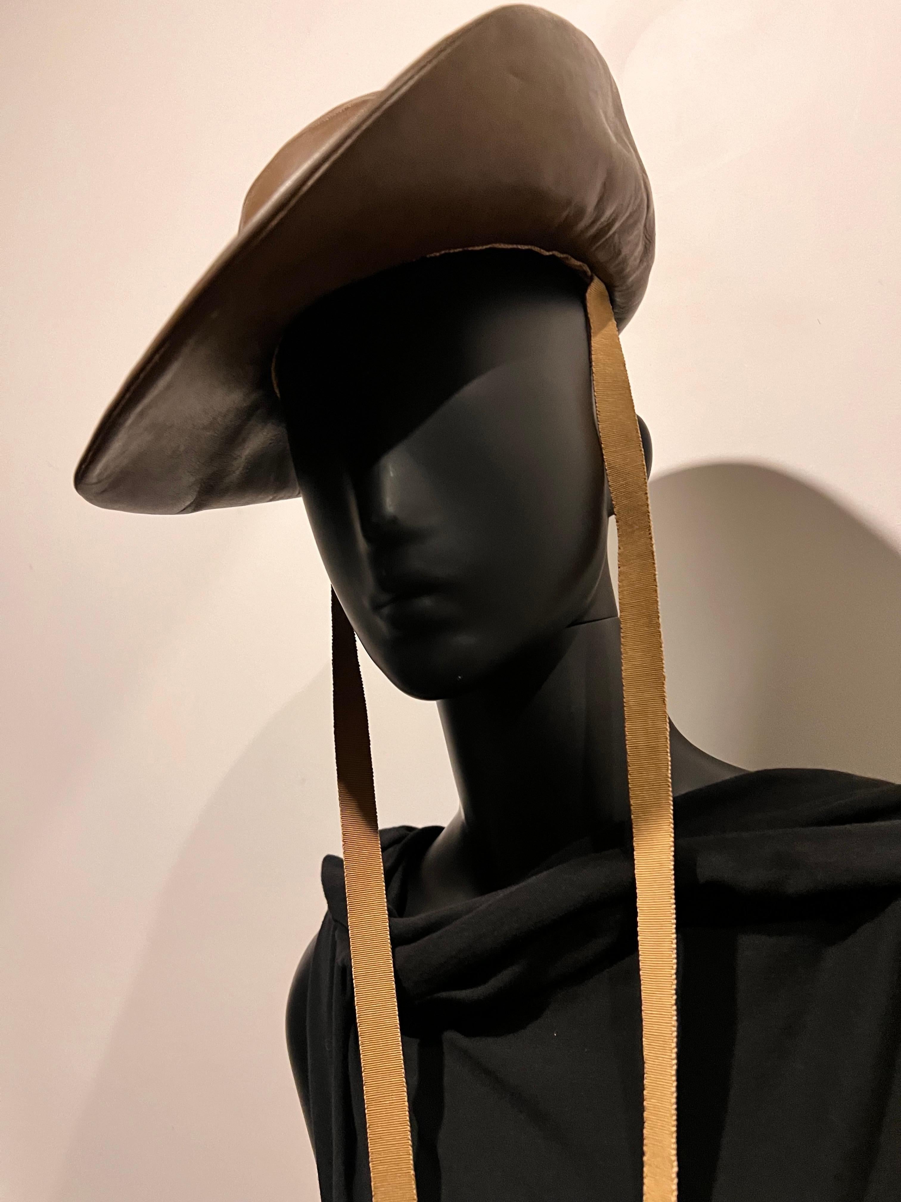 Beautiful and rare Vintage Bergdorf Goodman Made to order Hat in mocha brown kid leather. features decorative ties. 

By Bergdorf Goodman On The Plaza New York.