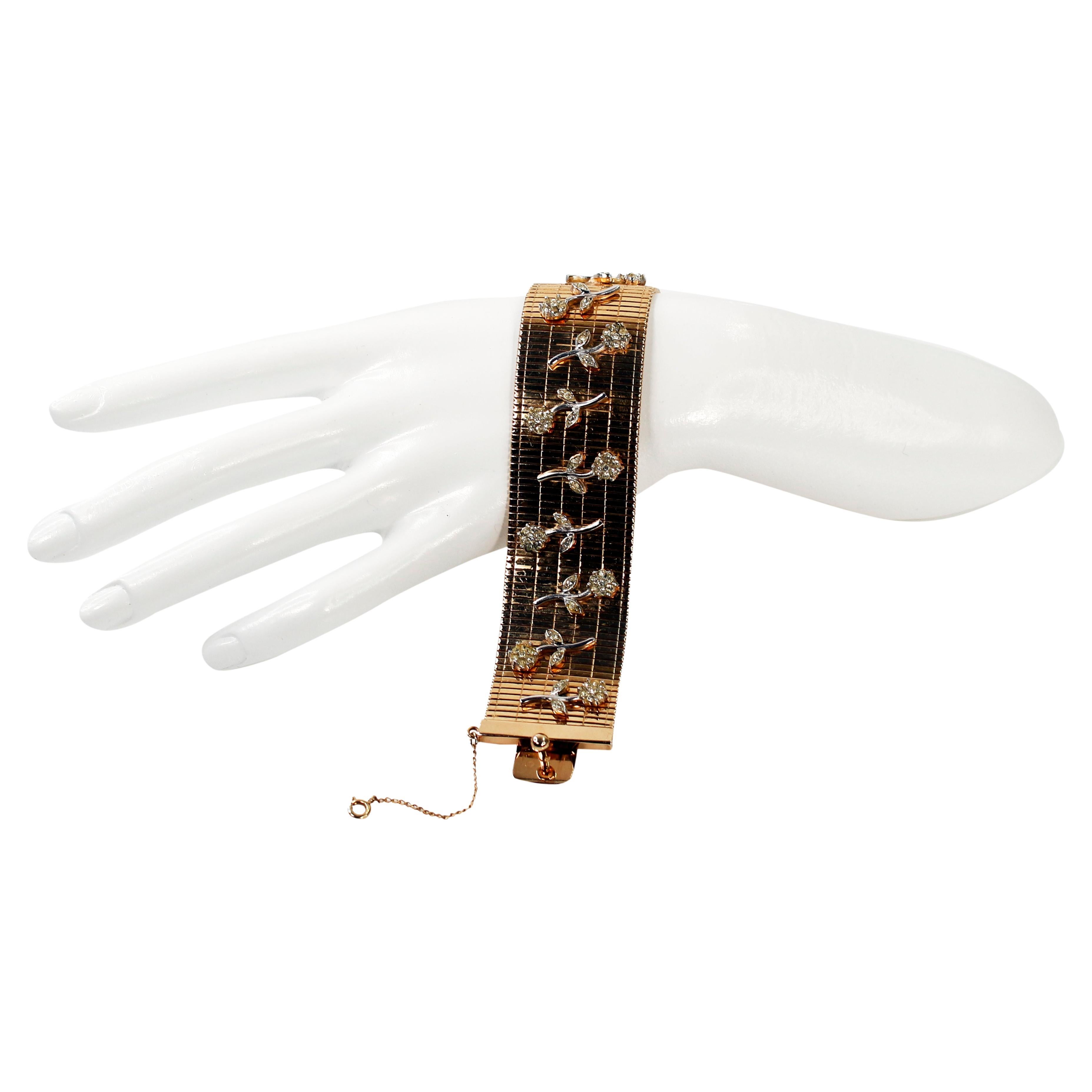 Vintage Bergere Flexible Gold Bracelet with Pieces of Silver Flower on Top.  A Costume Piece that mimics Fine.  Small Pave Crystal set on Top of the Gold Bracelet in Silver Tone Flowers. Exceptional.  This piece has all the attention to detail and