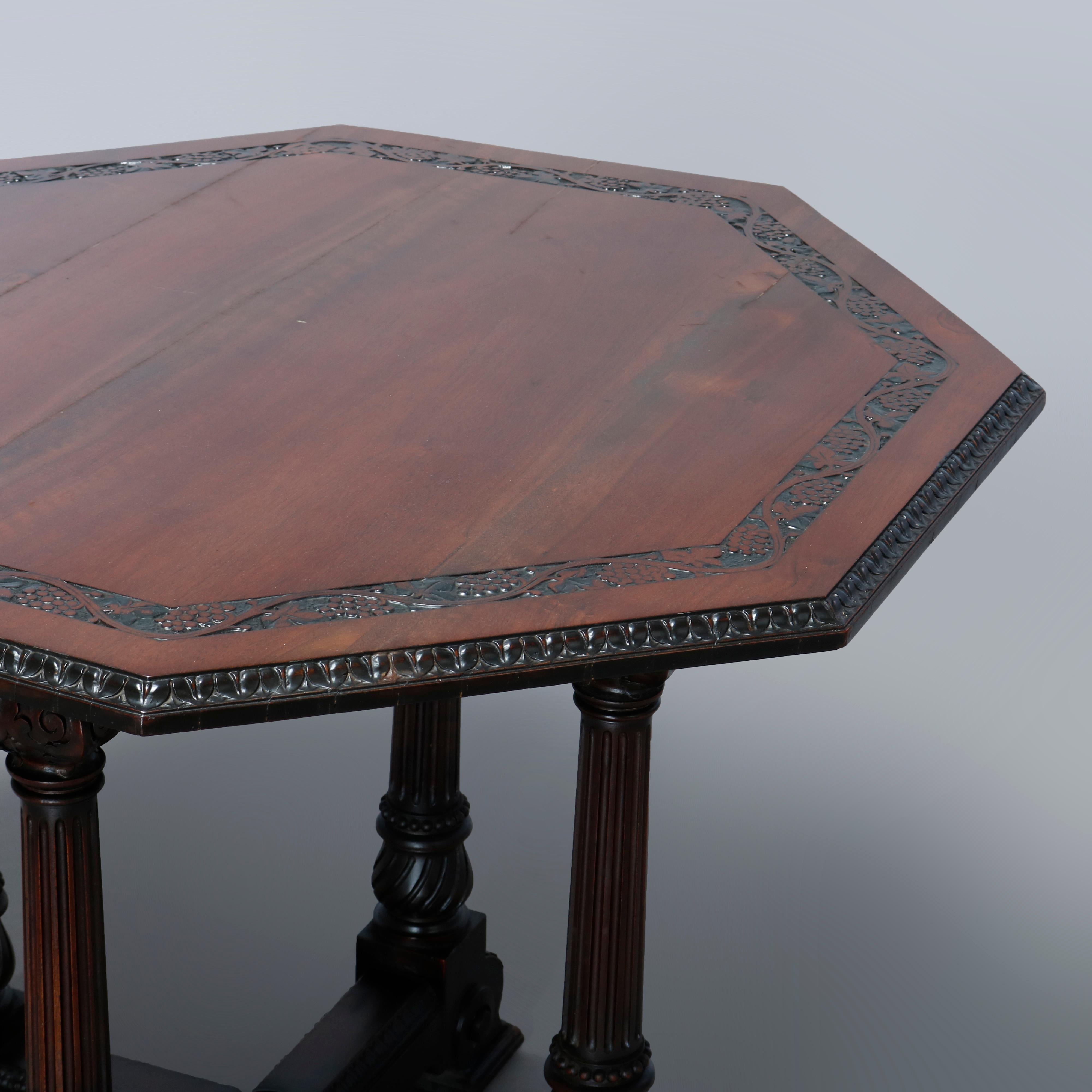 A vintage center table in the manner of Berkey & Gay offers walnut construction with octagonal top having carved grape and vine bordering raised on four reeded columns seated on base with scroll and acanthus feet, c1930.

Measures: 30.25