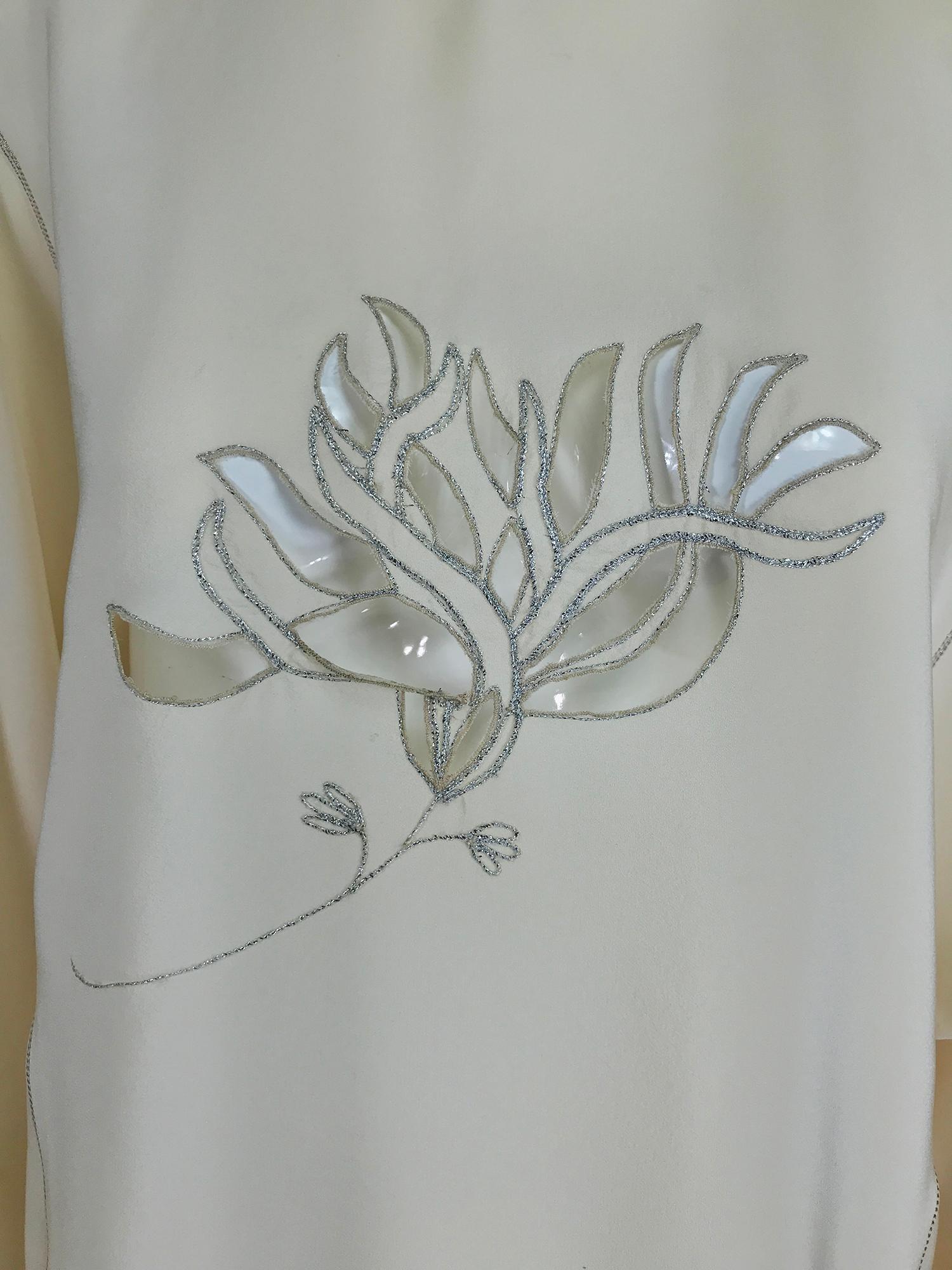 Vintage Bernard Perris, cream silk with silver metallic thread peek a boo, flower front blouse from the 1980s. Lightweight silk crepe with silver metallic stitching, the blouse has a stand up collar with a V at the top, there are 2 applied loops at
