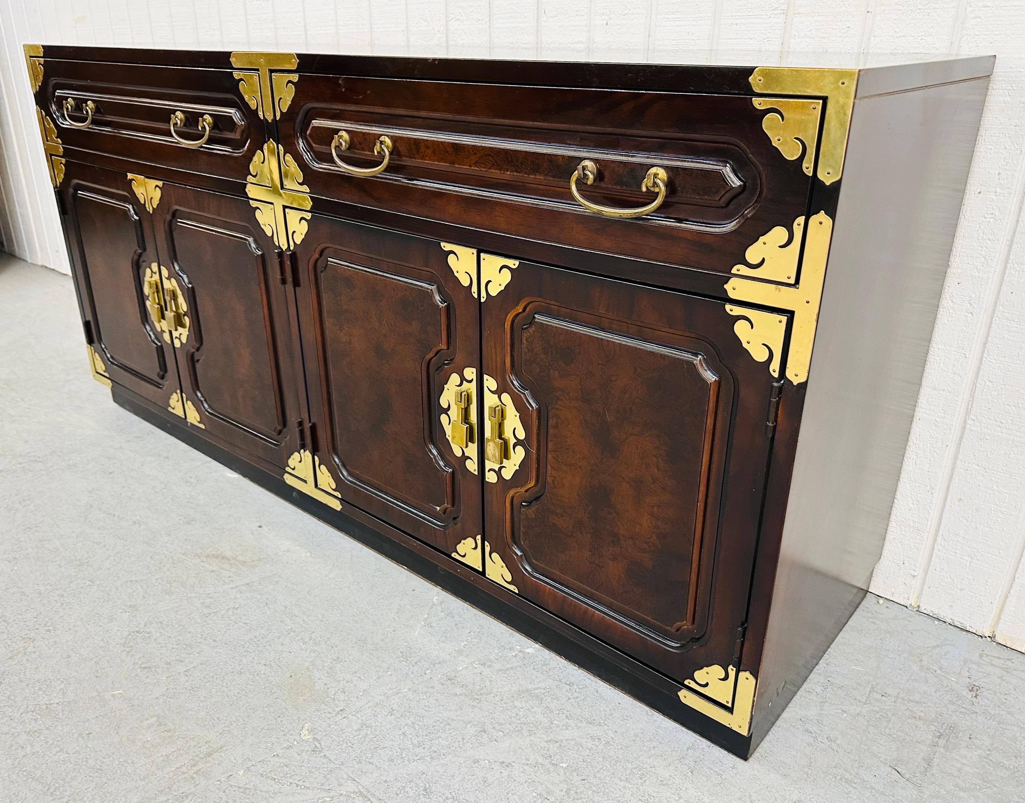 This listing is for a Vintage Bernhardt Chinoiserie Style Sideboard. Featuring a straight line design, two drawers that open up to storage space, four doors that open up to cabinet space, original brass hardware, a beautiful dark walnut finish.