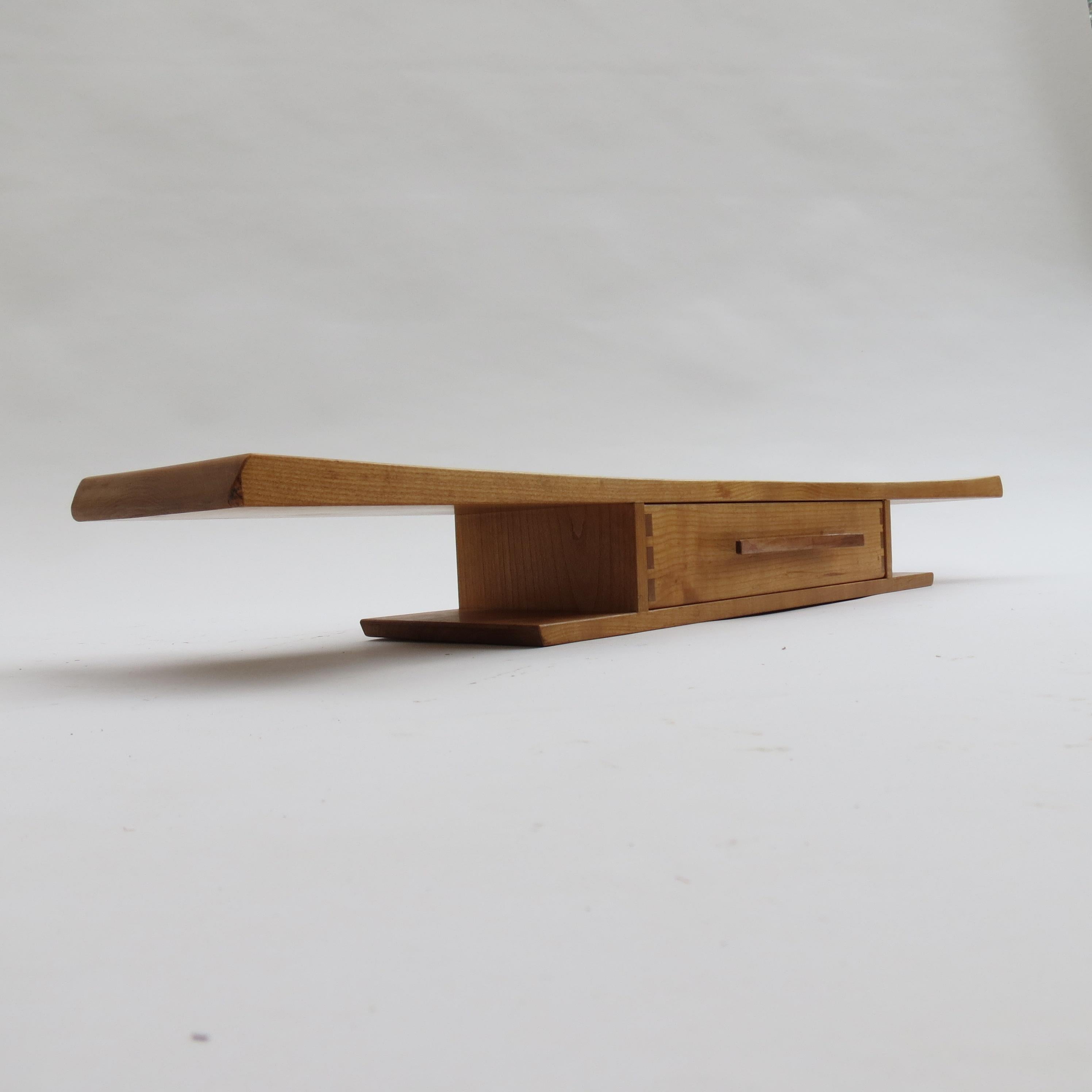 Wonderful floating shelf with drawer.  This piece is bespoke made and dates from the 1990s.

Made from solid Sycamore with Walnut handle to the drawer.  Very nicely executed dovetail detail to the front of the drawer.  The shelf is Japanese in its
