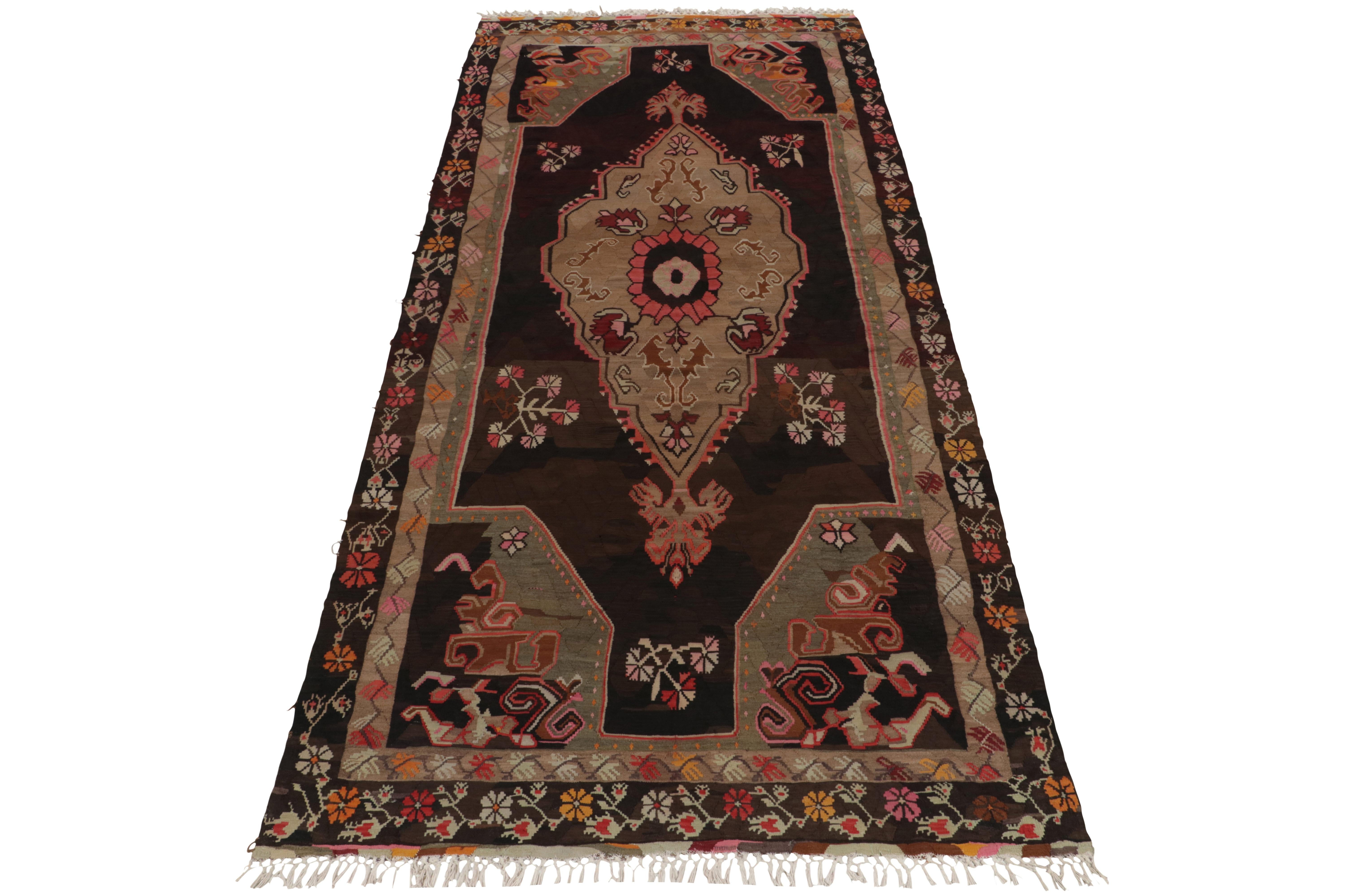 Handwoven in wool, a 6x14 vintage Bessarabian kilim rug from our flatweave selections. Originating from Turkey circa 1950-1960, the creation carries nomadic inspiration with a striking medallion in gorgeous beige, brown & pink accents. The border