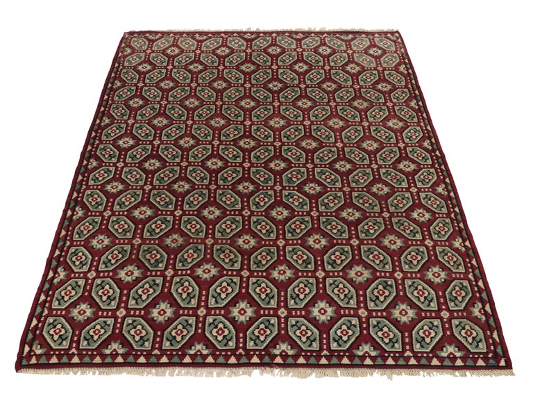 Handwoven in wool, a vintage Bessarabian kilim rug from Turkey circa 1950-1960—now entering our flatweave collection. The rare edition of the coveted style relishes a geometric pattern inspired by mid century aesthetics in maroon and aegean