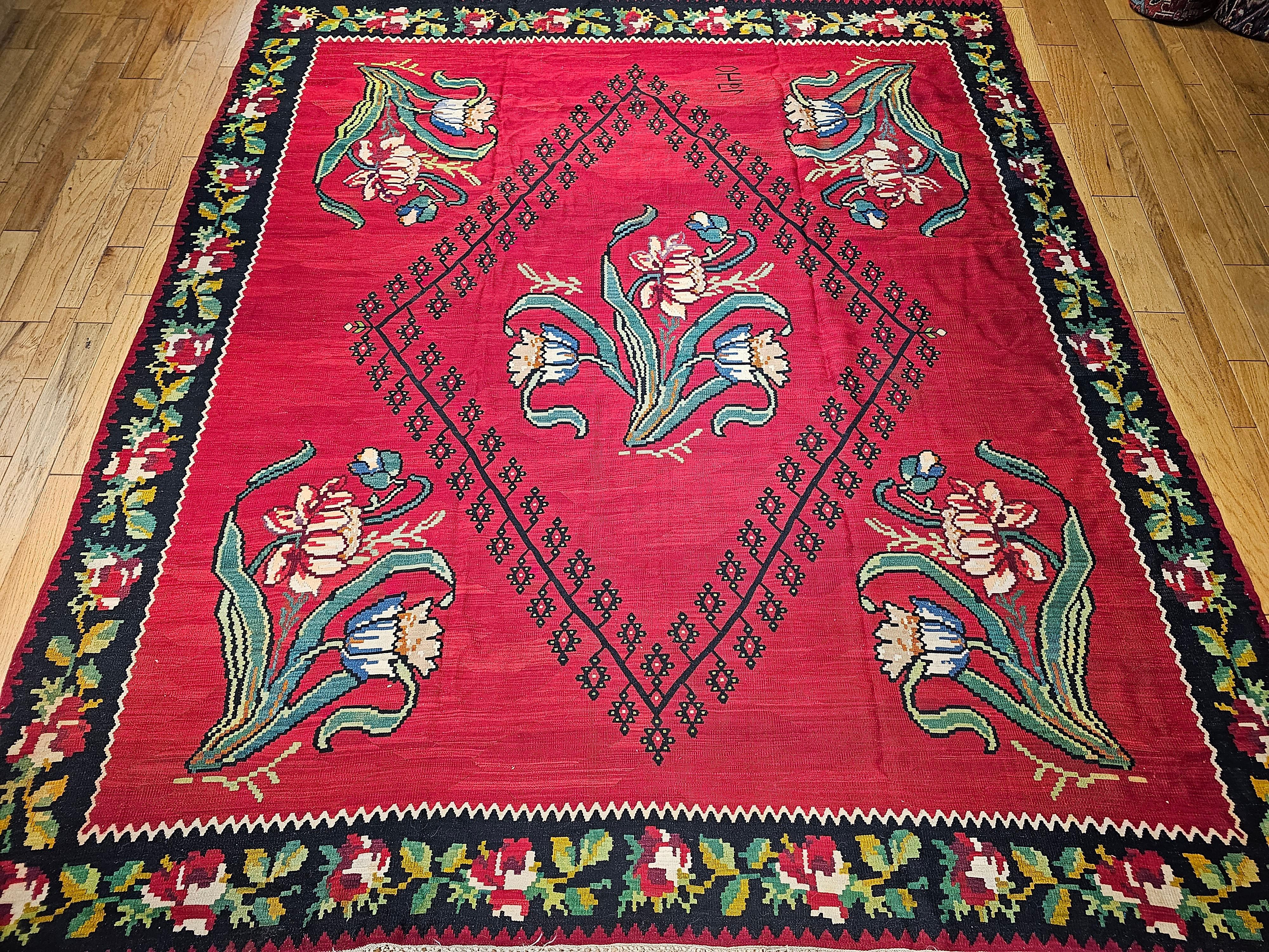  Room Size Bessarabian Turkish kilim in beautiful bright colors and design from the first half of the 1900s. The Kilim has a brilliant red color in the field and has the design of 5 bouquets of flowers one in the center and the other four in the